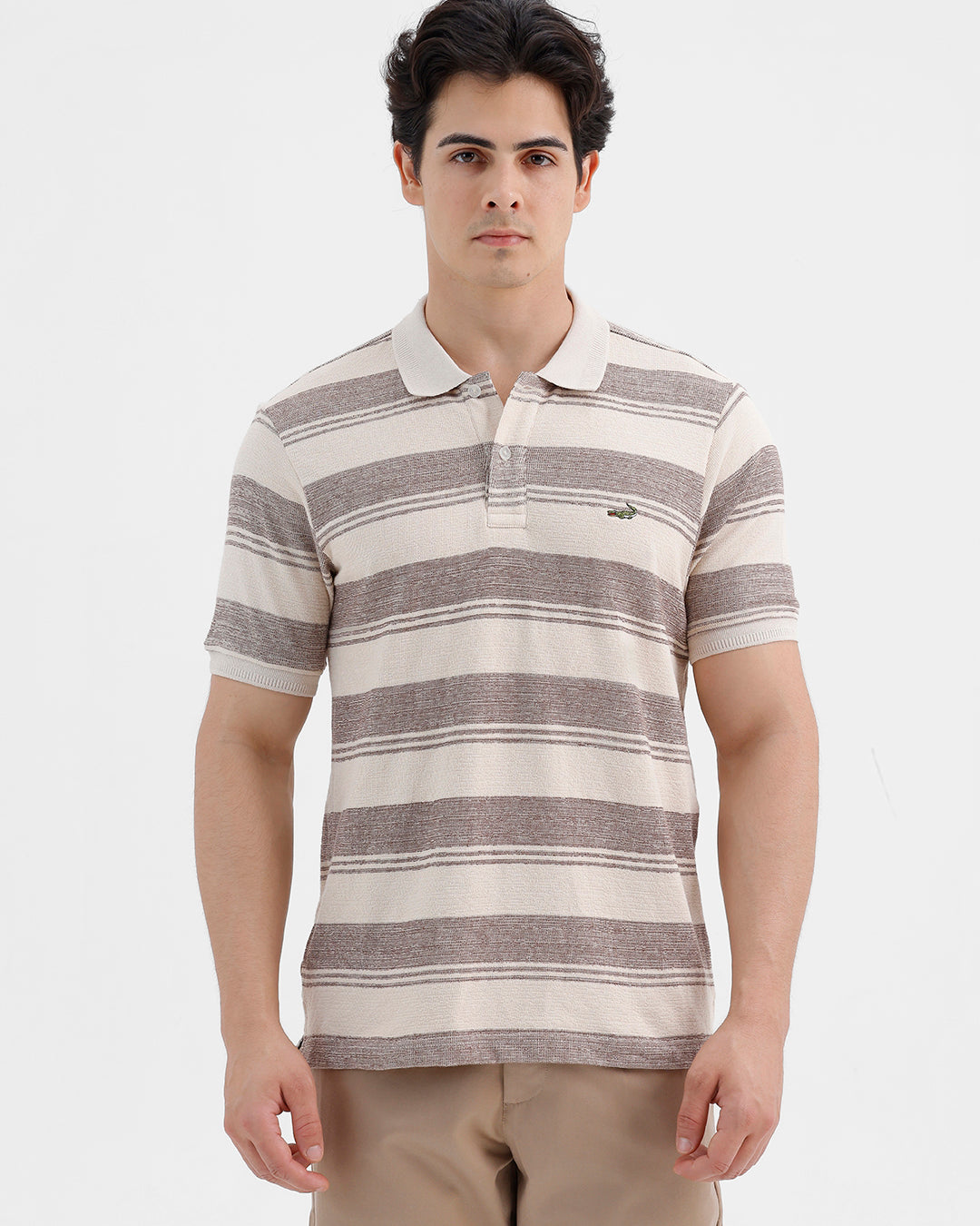 Man wearing a retro classic checked all over printed polo t shirt with casual styling on a gray background