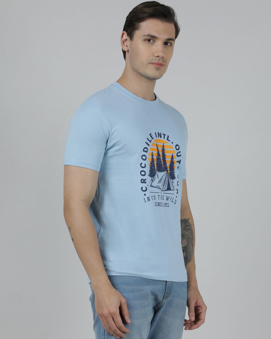Man wearing a blue typography printed single jersey cotton t shirt blue on a light gray background