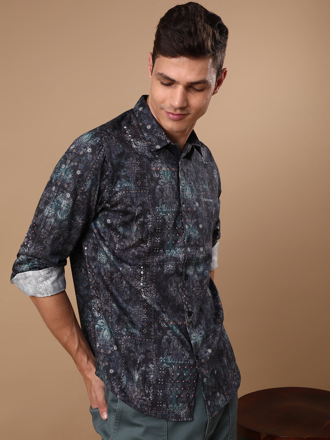 Man wearing a navy printed full sleeve 100% cotton navy casual shirt on a light gray background