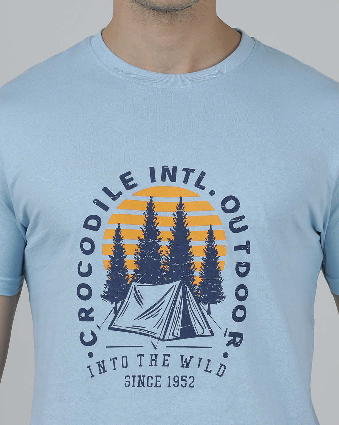 Man wearing a blue typography printed single jersey cotton t shirt blue on a light gray background
