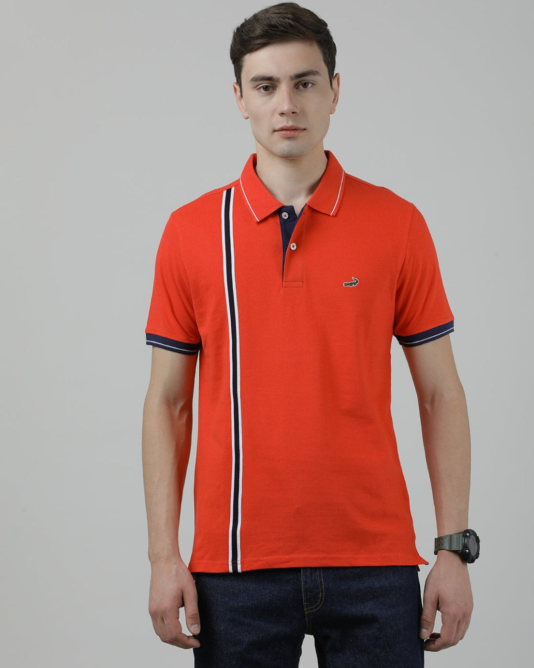 Man wearing a red printed red polo t shirt with casual styling on a gray background