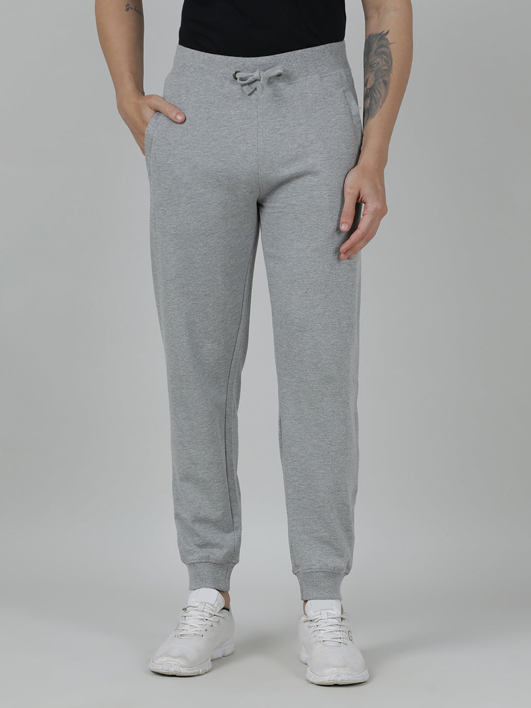 Person wearing gray sweatpants on a plain background