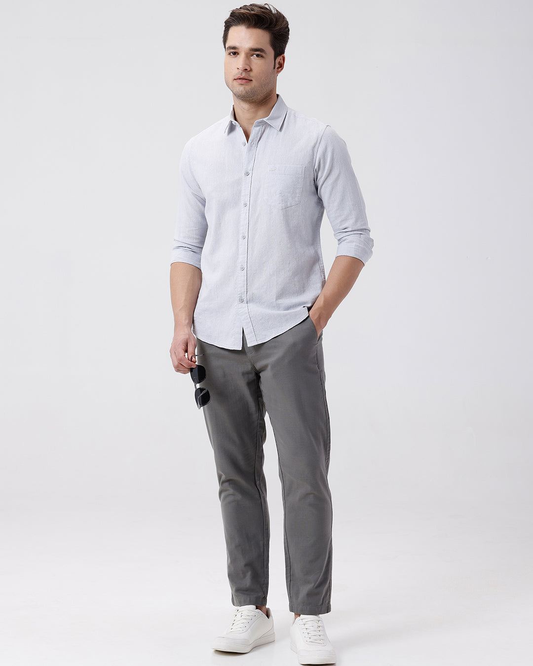 Man wearing a grey rib textured cotton shirt grey on a light gray background