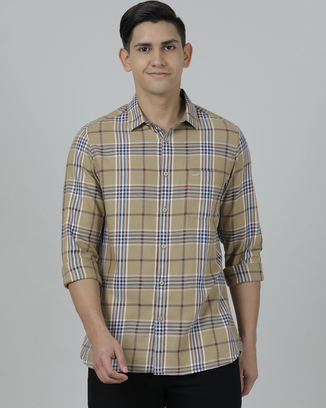 Man wearing a brown khaki brown checked full sleeve 100% cotton shirt with casual styling on a gray background