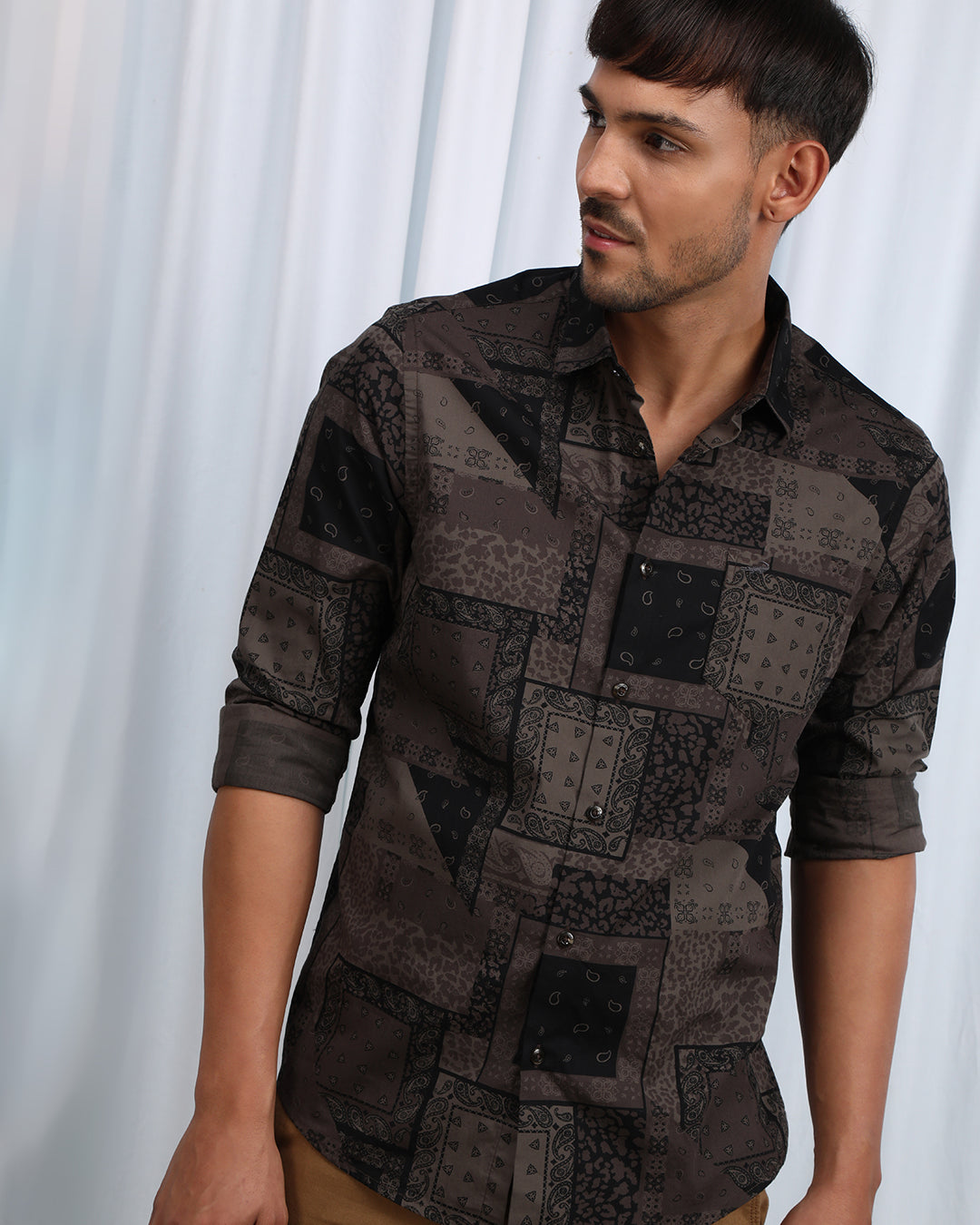 Man wearing a brown brown printed full sleeve casual 100% cotton shirt with casual styling on a gray background