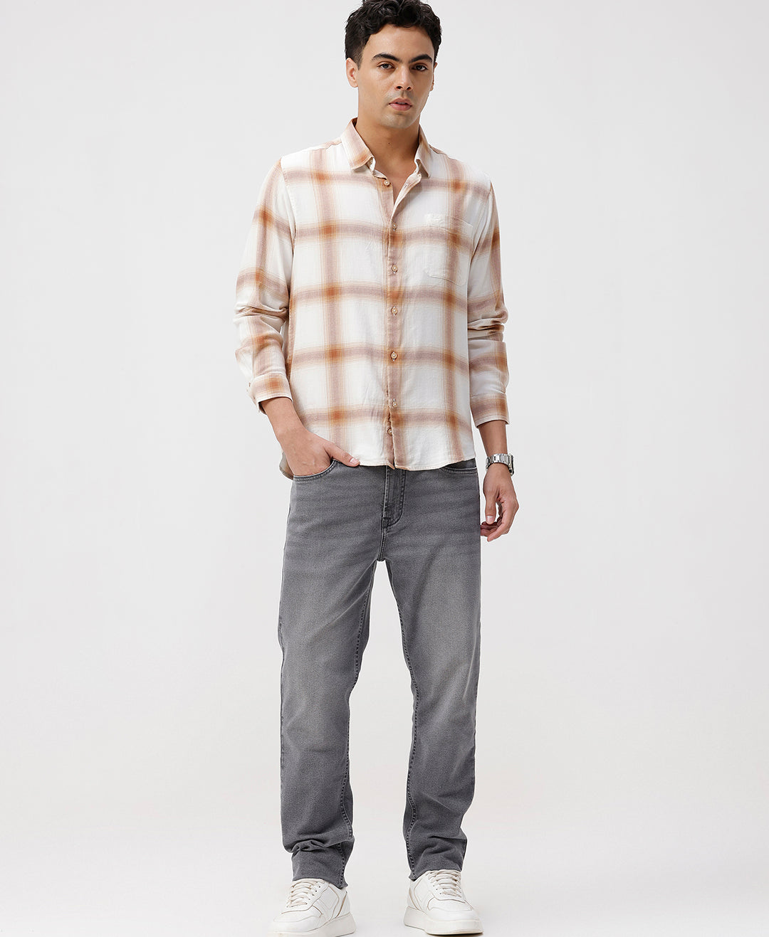 Man wearing a red textured grunge print shirt with casual styling on a gray background