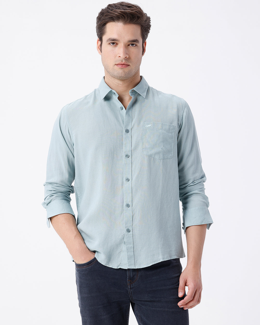 Man wearing a green linen blend shirt in green on a light gray background