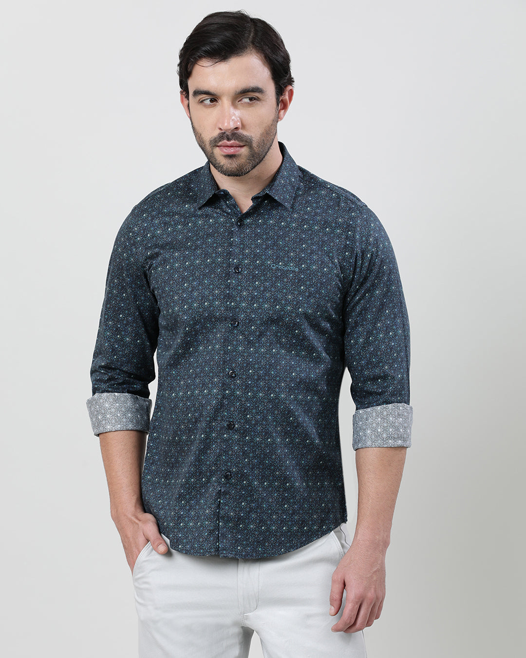 Man wearing a blue dark blue printed full sleeve 100% cotton shirt with casual styling on a gray background