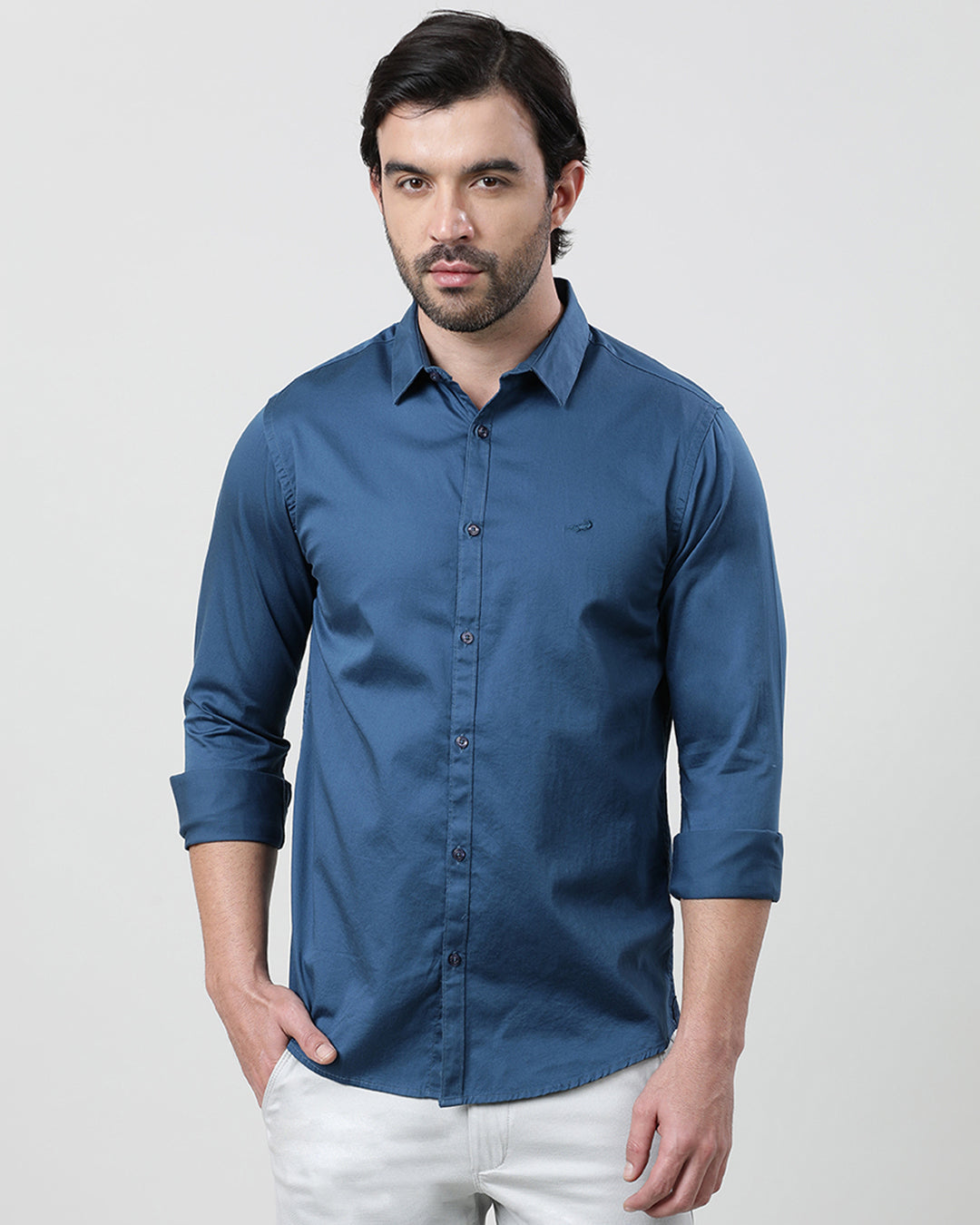 Man wearing a blue royal blue solid full sleeve 100% cotton shirt with casual styling on a gray background