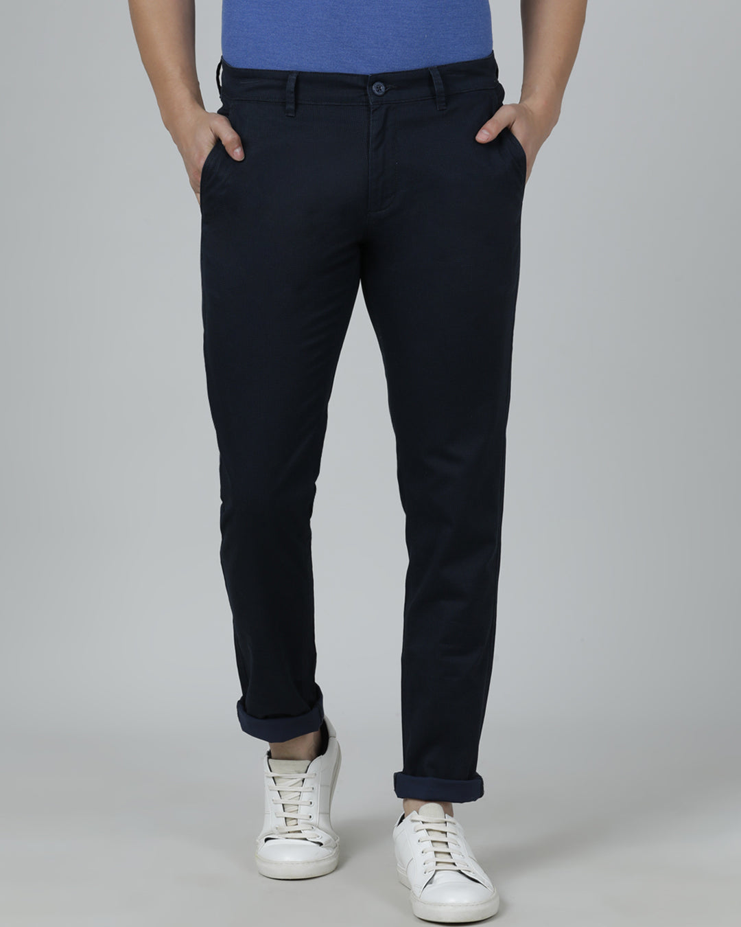 Man wearing a navy navy casual printed trouser with casual styling on a gray background