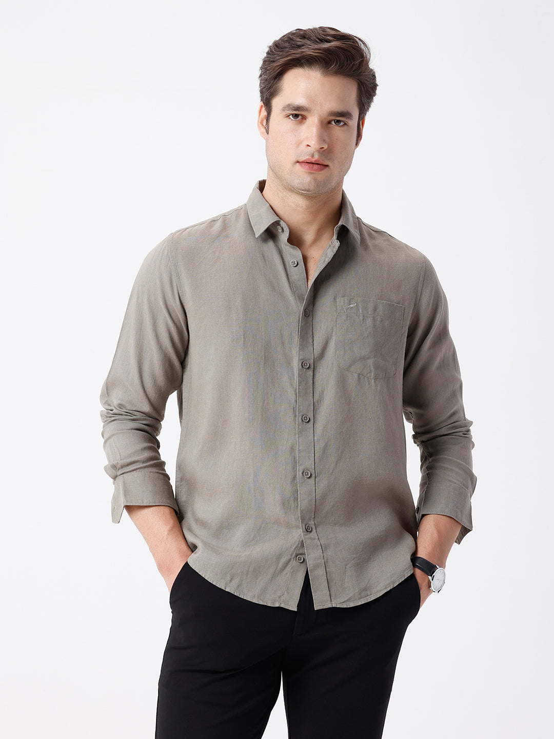 Man wearing a beige linen blend shirt in dark beige on a light gray background