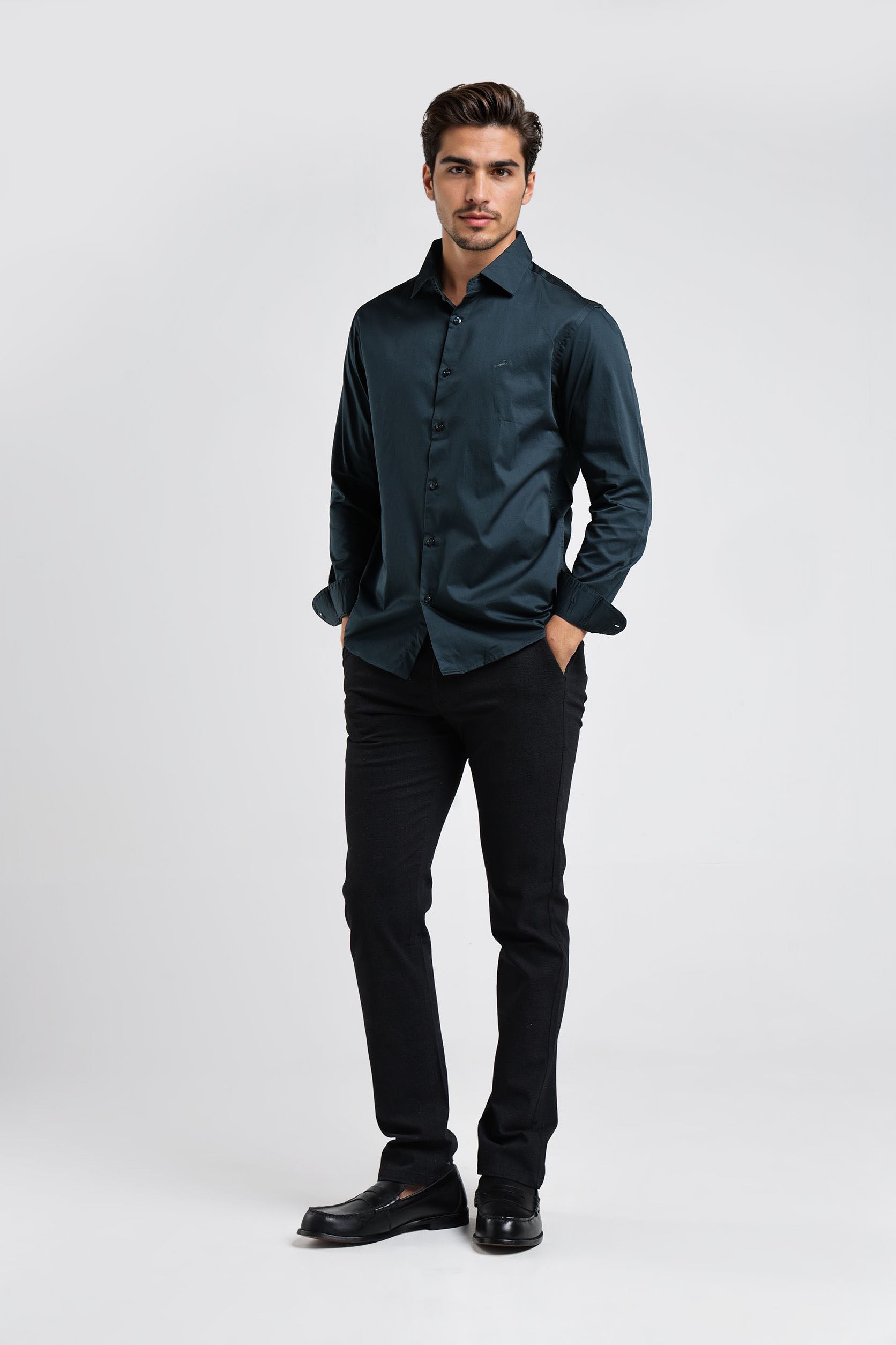 Man wearing a dark green shirt and black pants on a white background