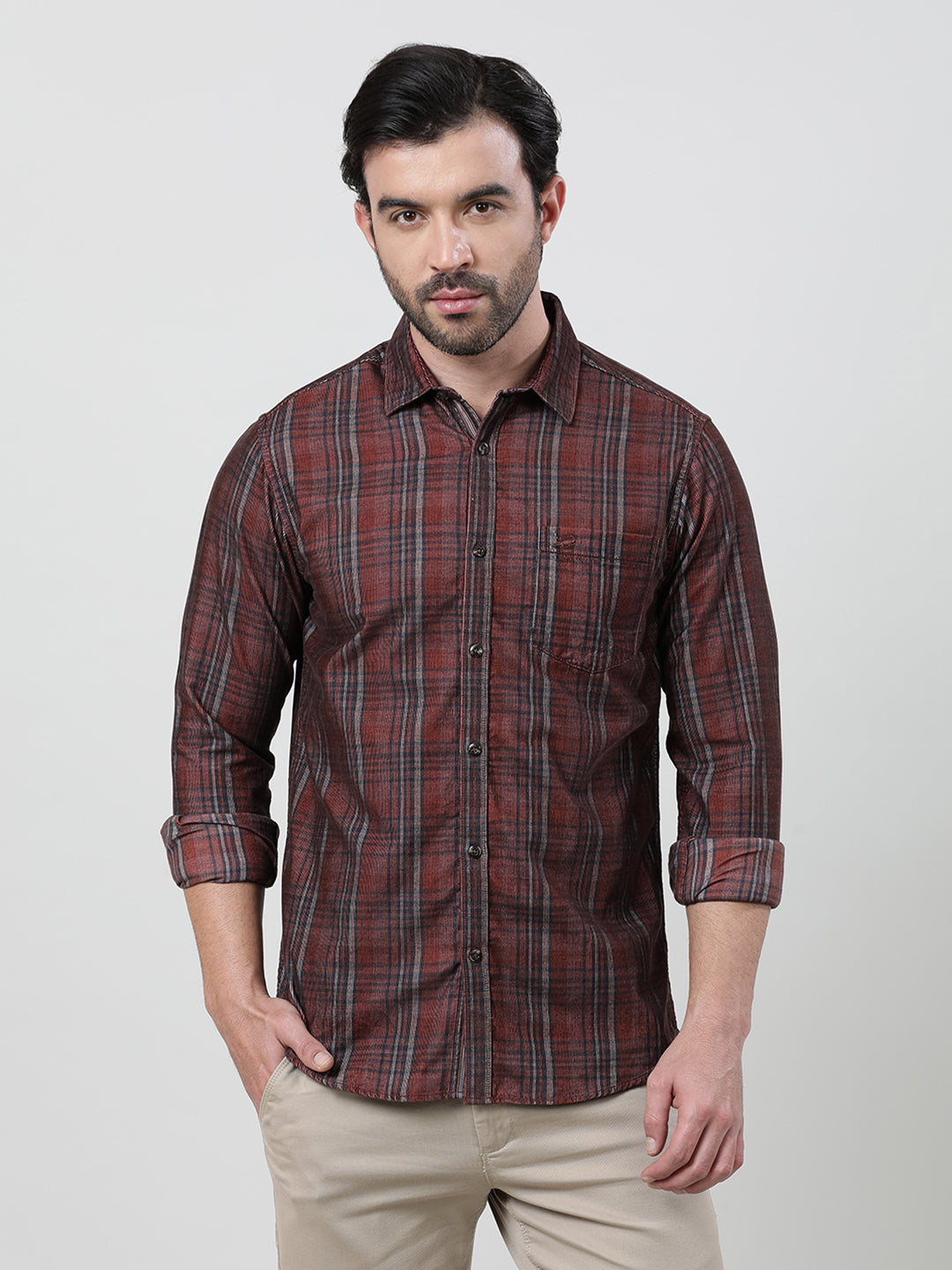 Man wearing a brown rust brown checked full sleeve 100% cotton shirt with casual styling on a gray background