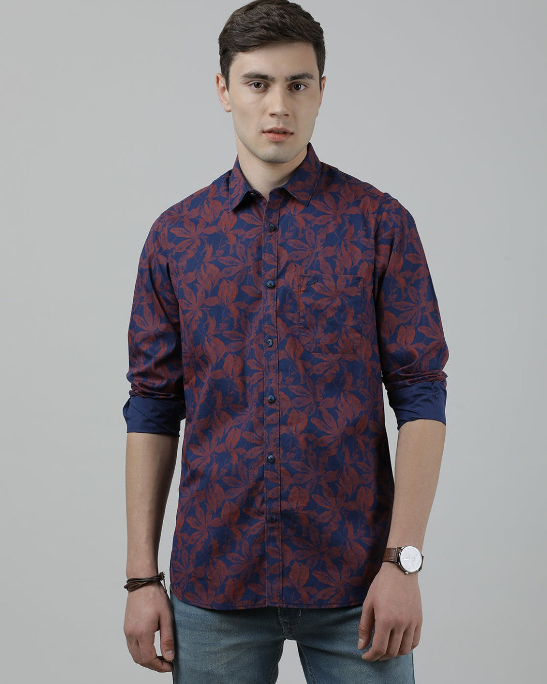Man wearing a navy navy printed casual full sleeve shirt with casual styling on a gray background