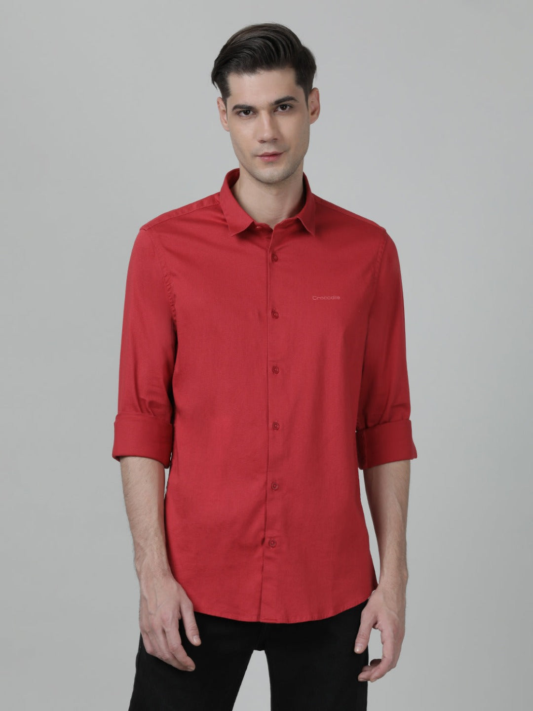 Man wearing a red tomato red solid full sleeve shirt on a light gray background