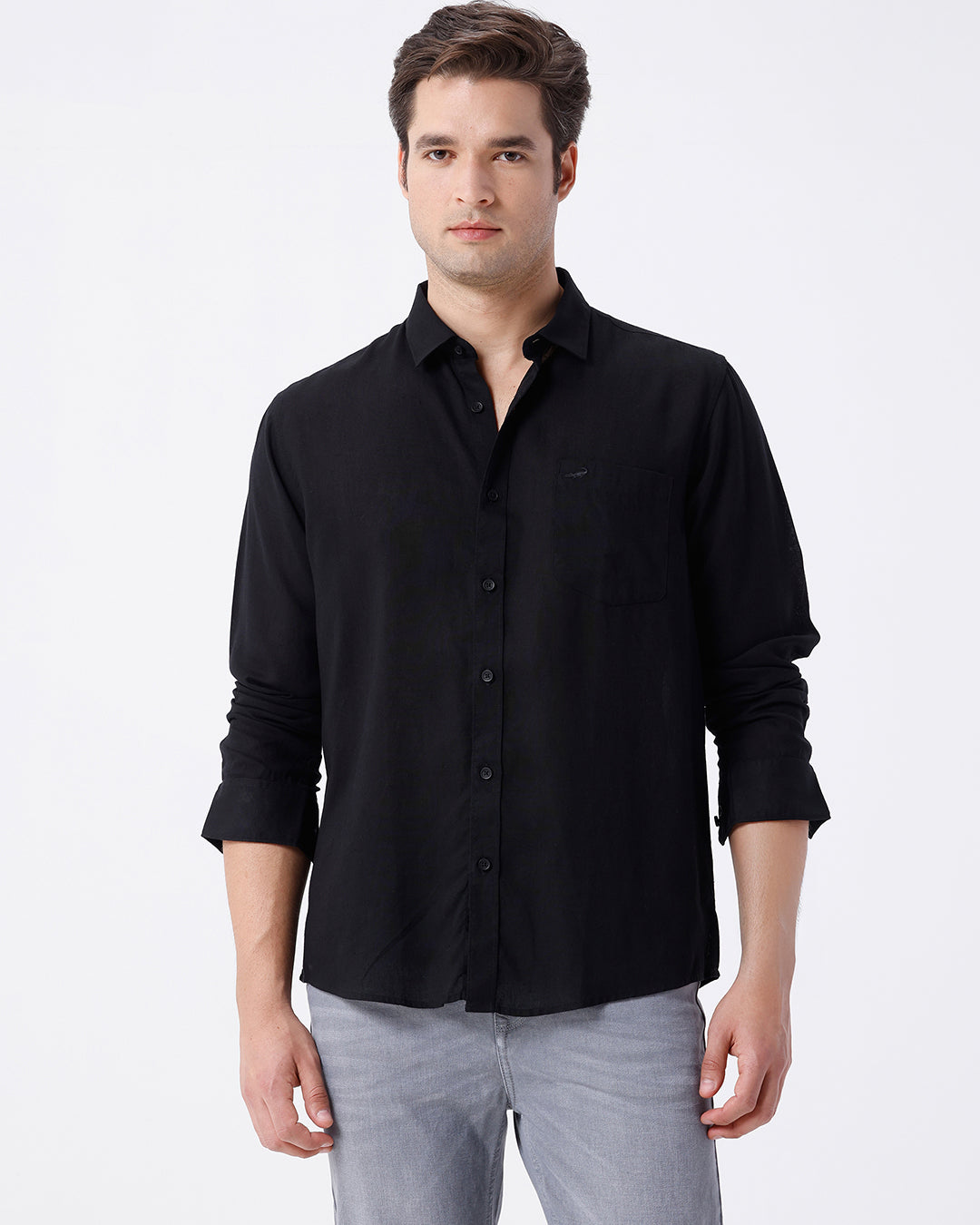 Man wearing a black linen blend shirt in black with casual styling on a gray background