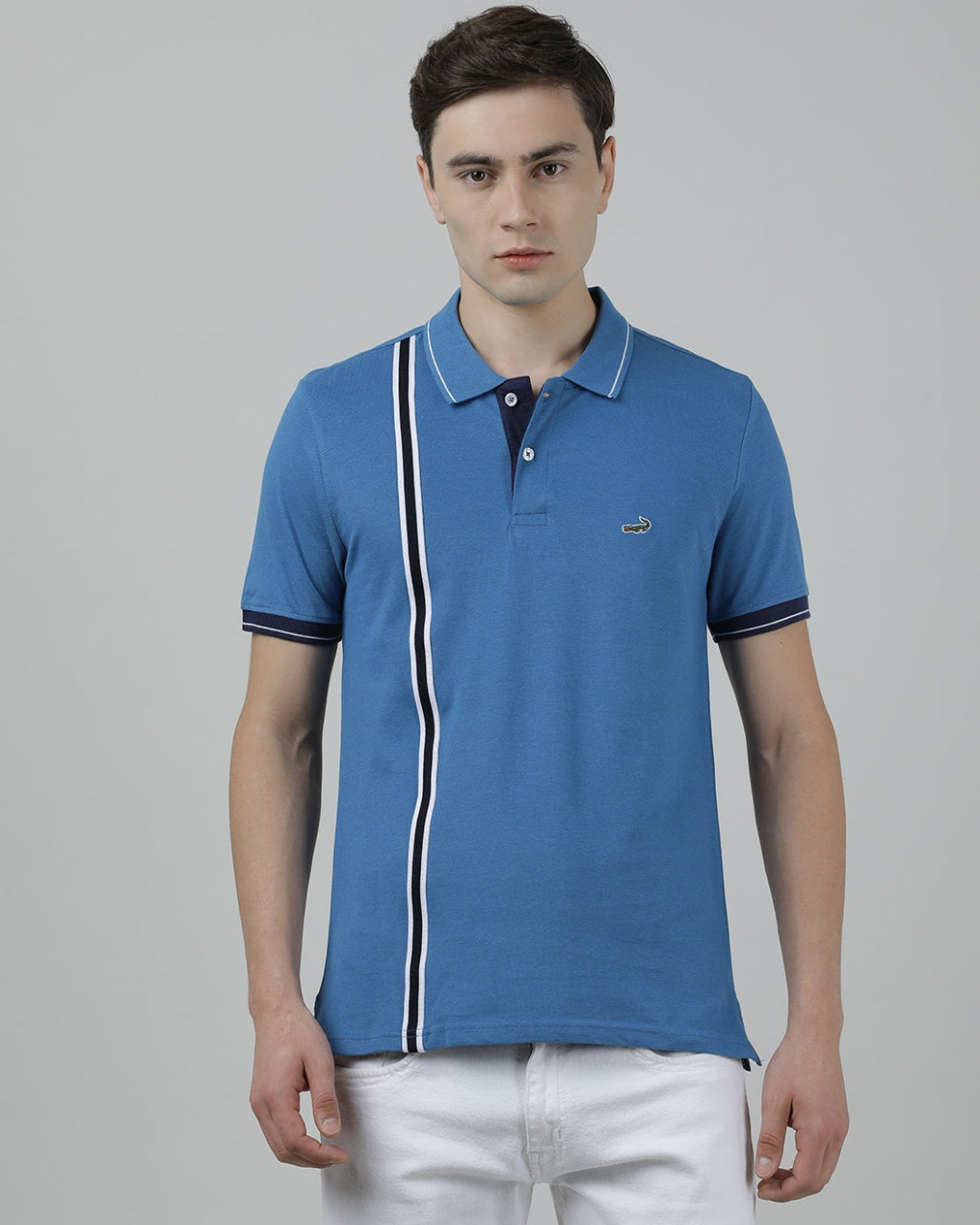 Man wearing a blue atlantic blue printed polo t shirt with casual styling on a gray background
