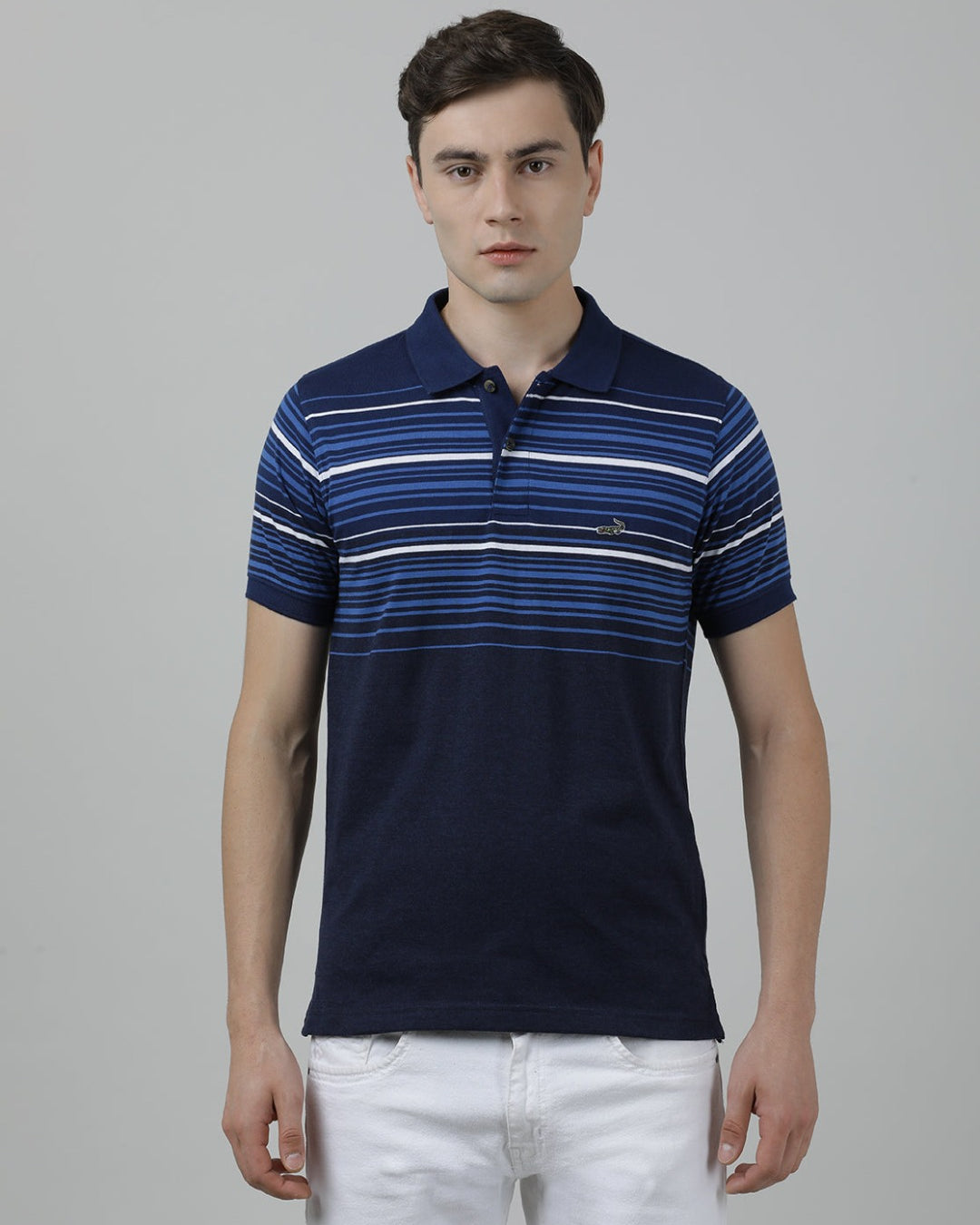 Man wearing a blue striped casual polo t shirt blue on a light gray background