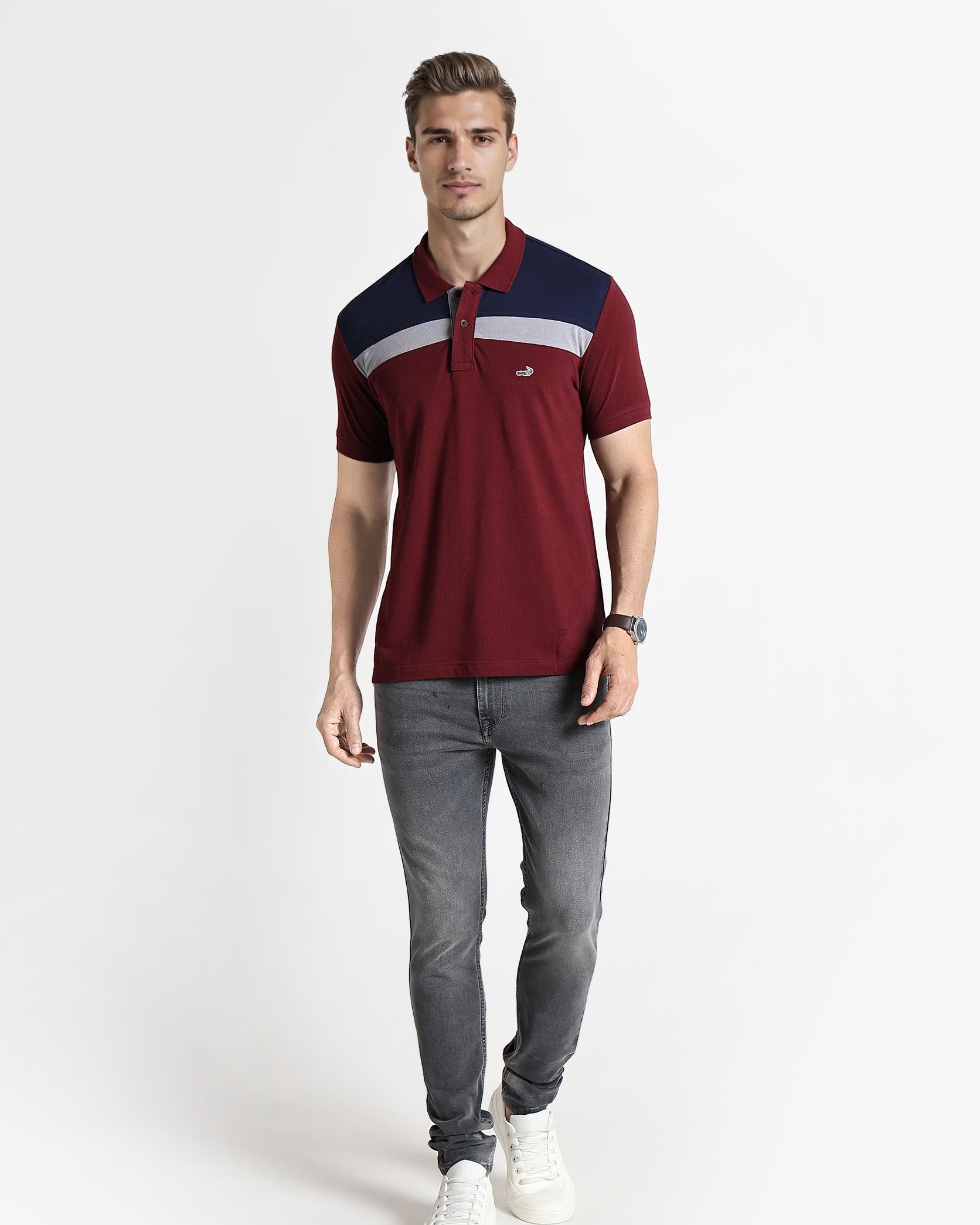 Man wearing a maroon polo shirt with navy and white accents on a white background