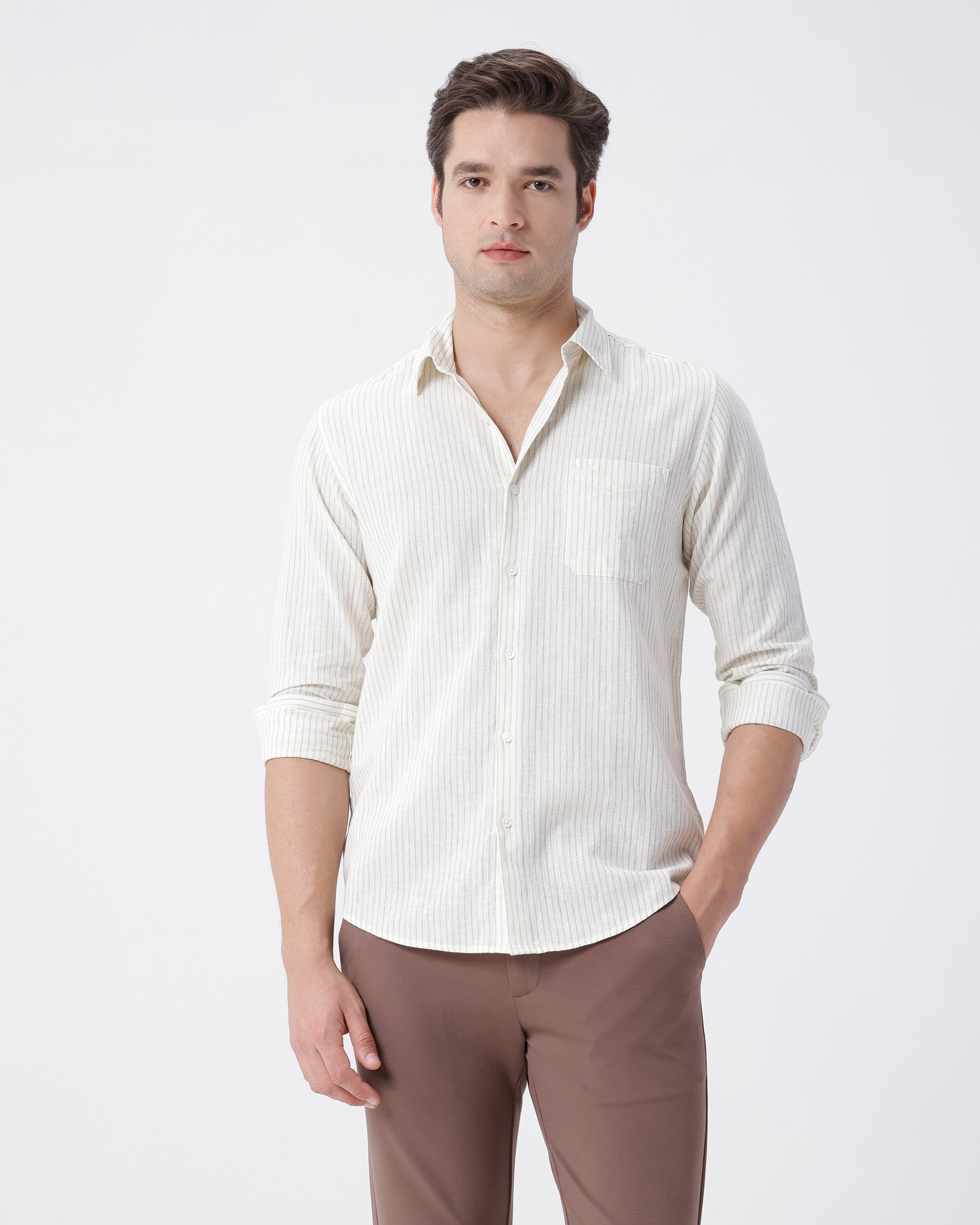 Man wearing a cotton linen stripe shirt with casual styling on a gray background