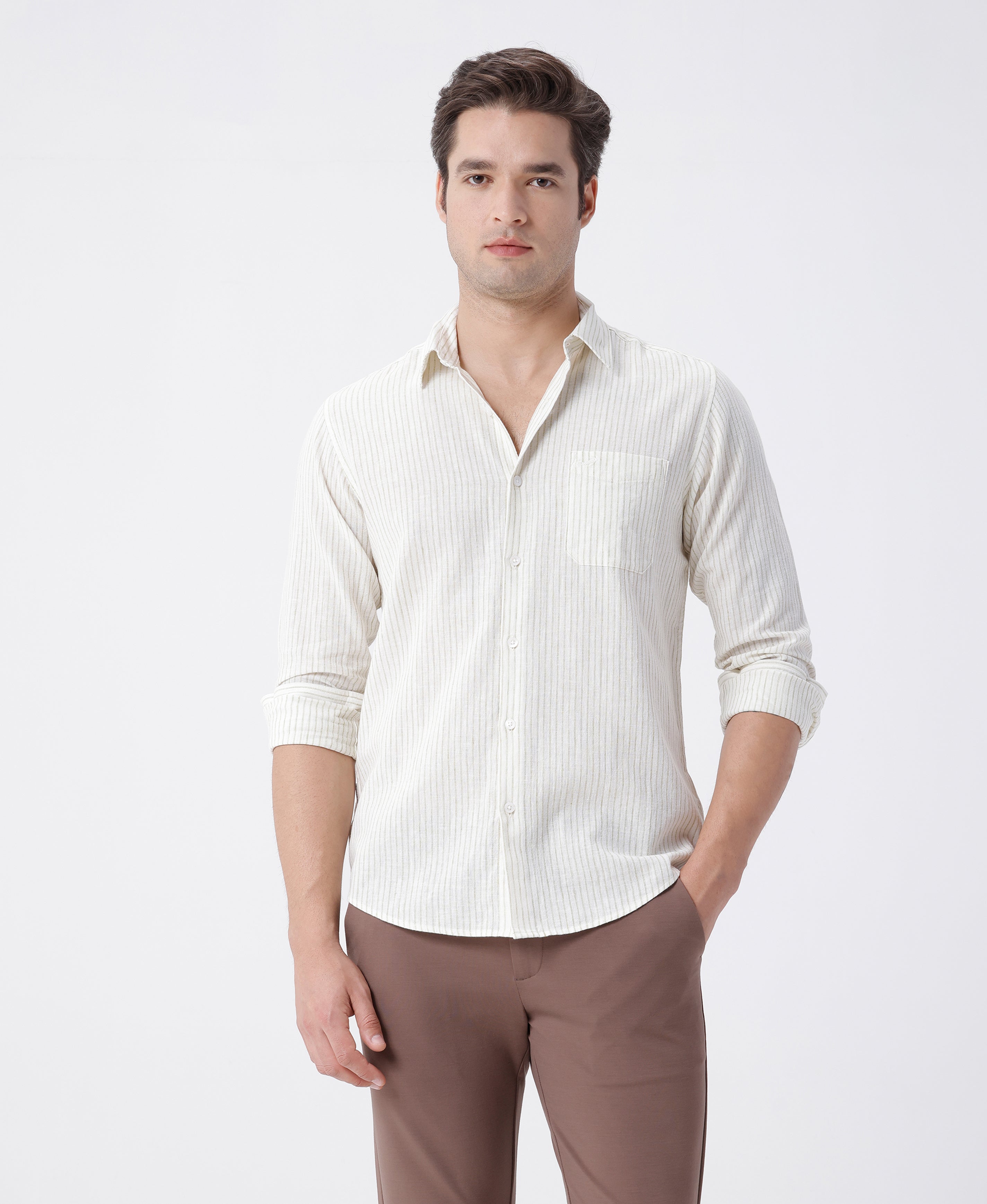 Man wearing a cotton linen stripe shirt with casual styling on a gray background