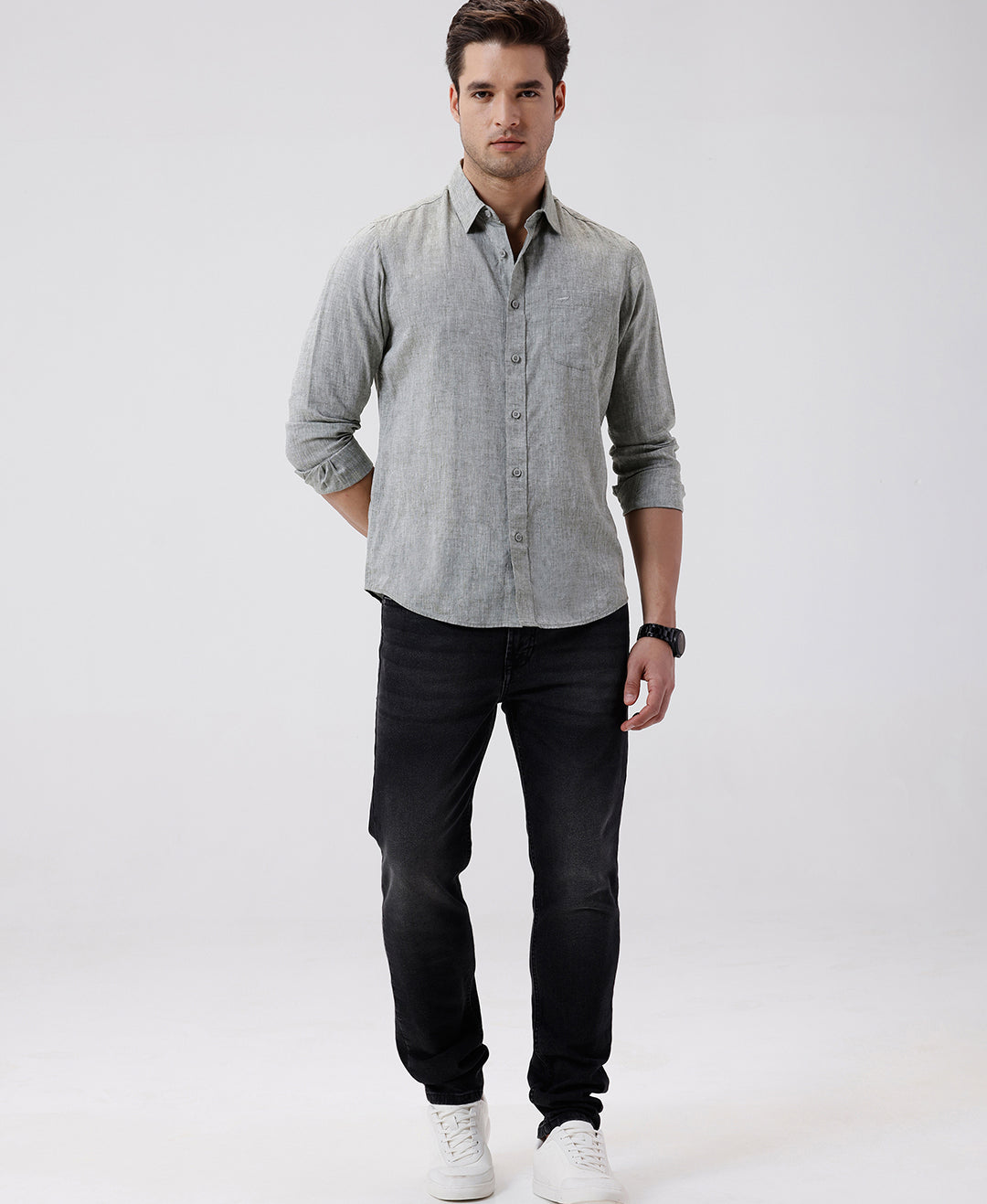 Man wearing a green premium tensil linen shirt dark green on a light gray background