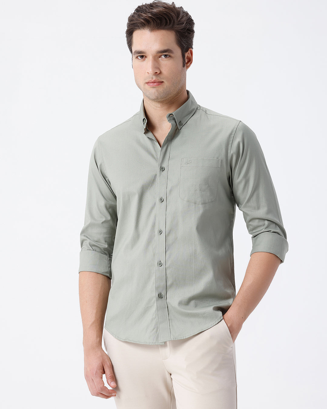 Man wearing a green smart series premium oxford shirt green with casual styling on a gray background