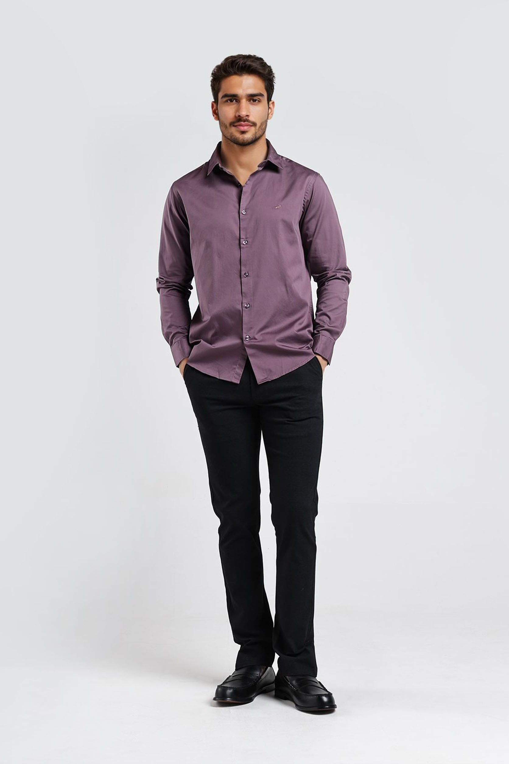 Man wearing a purple shirt and black pants on a white background