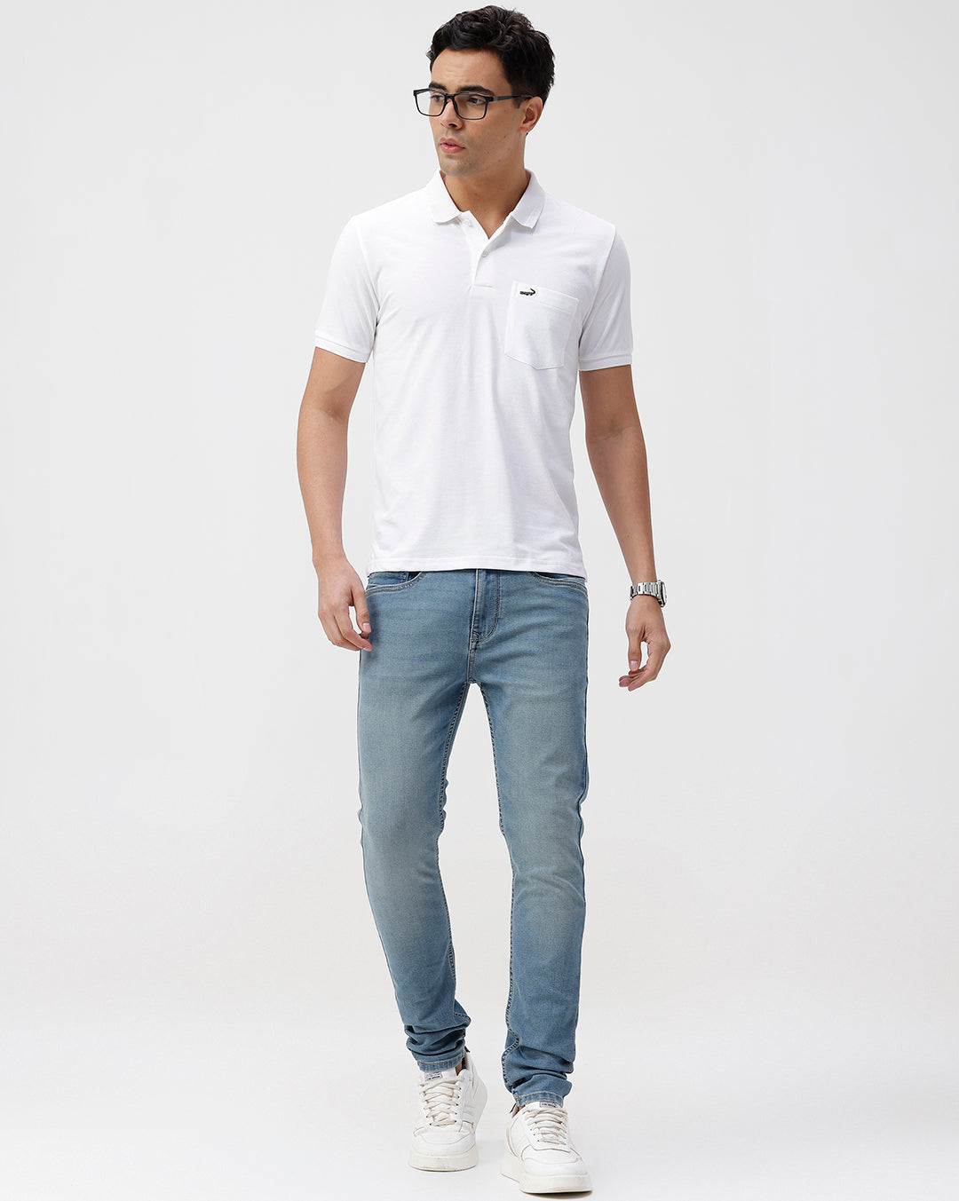 Man wearing a white solid white slim fit polo t shirt with casual styling on a gray background