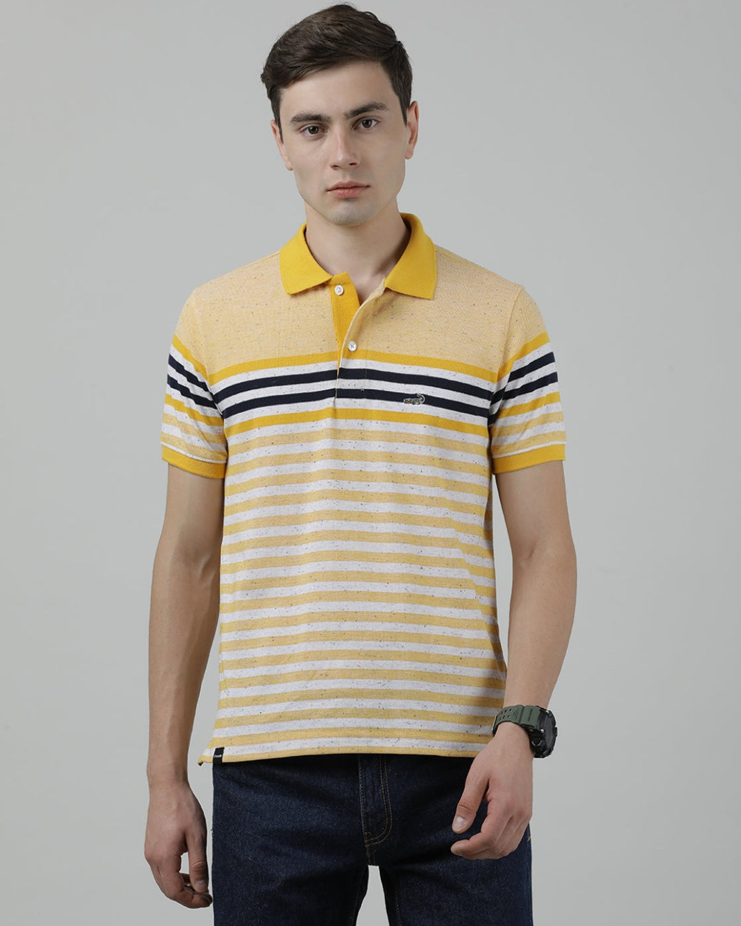 Man wearing a yellow yellow striped polo t shirt on a light gray background