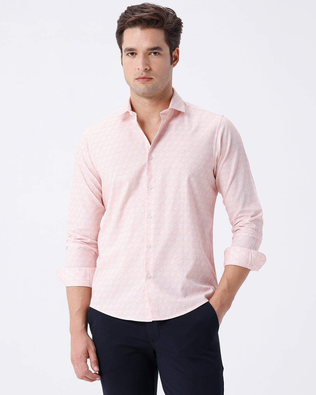 Man wearing a geomentic diamond print shirt orange on a light gray background