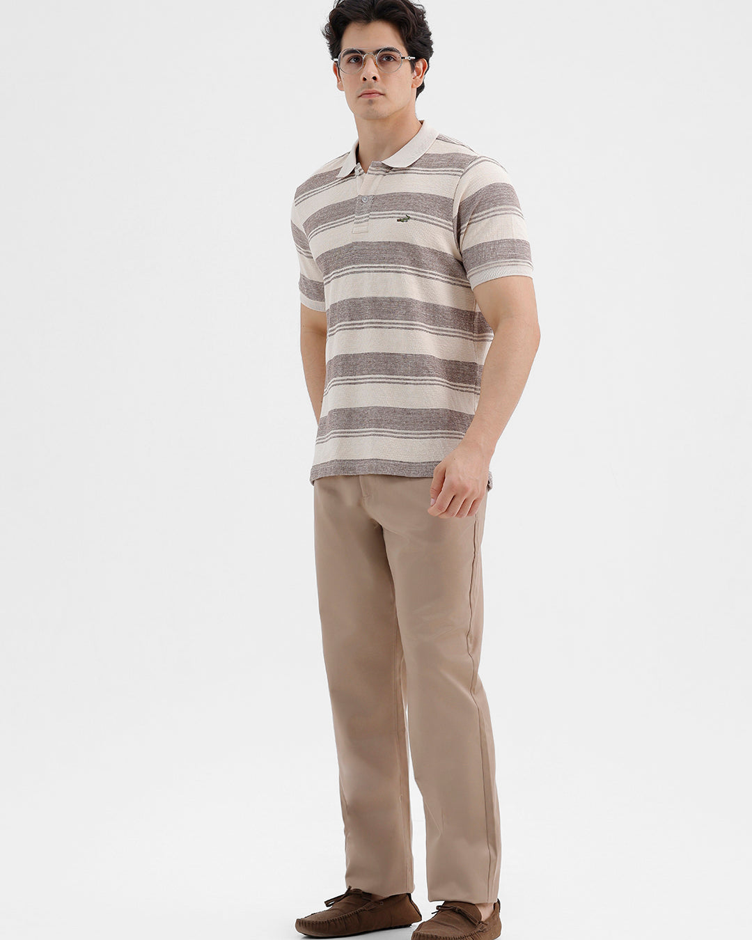 Man wearing a retro classic checked all over printed polo t shirt with casual styling on a gray background