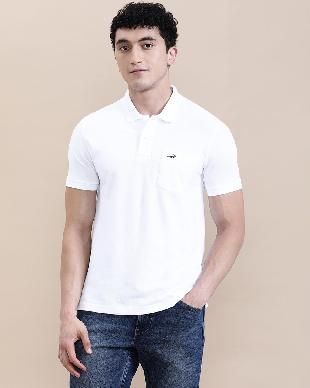 Man wearing a white white solid polo t shirt with pocket with casual styling on a gray background
