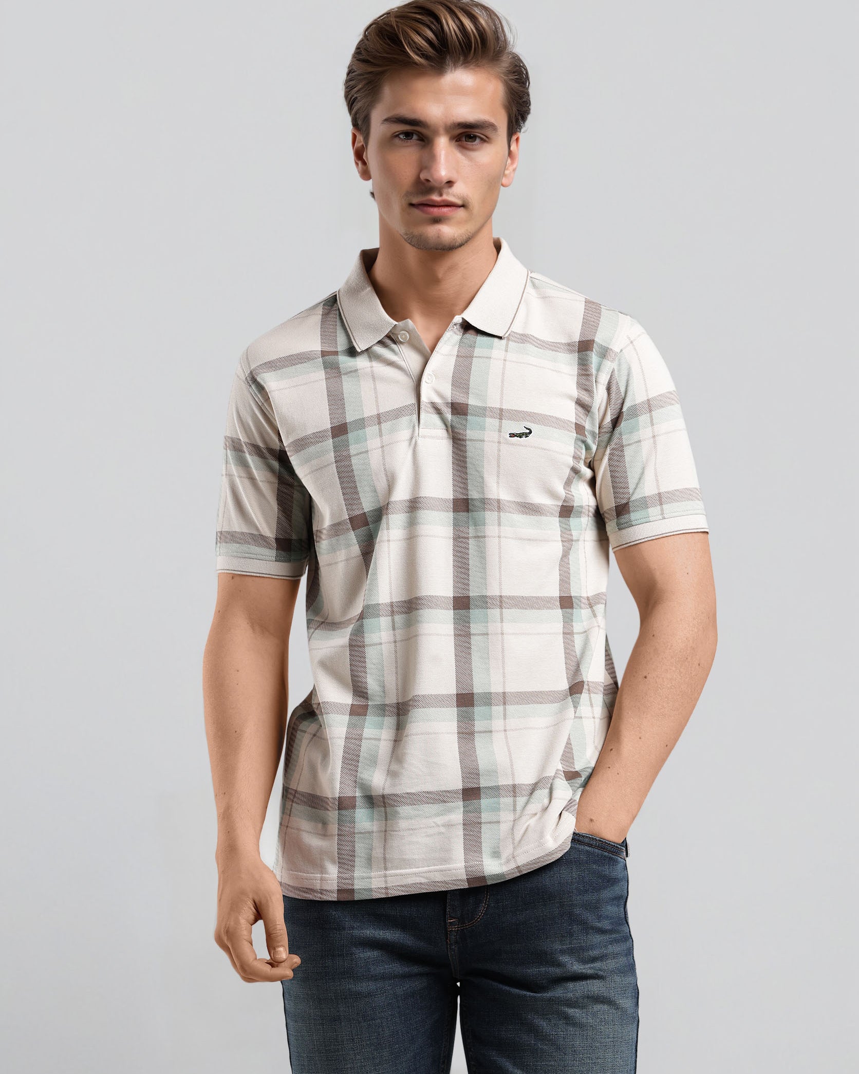 Man wearing a plaid shirt and jeans on a gray background