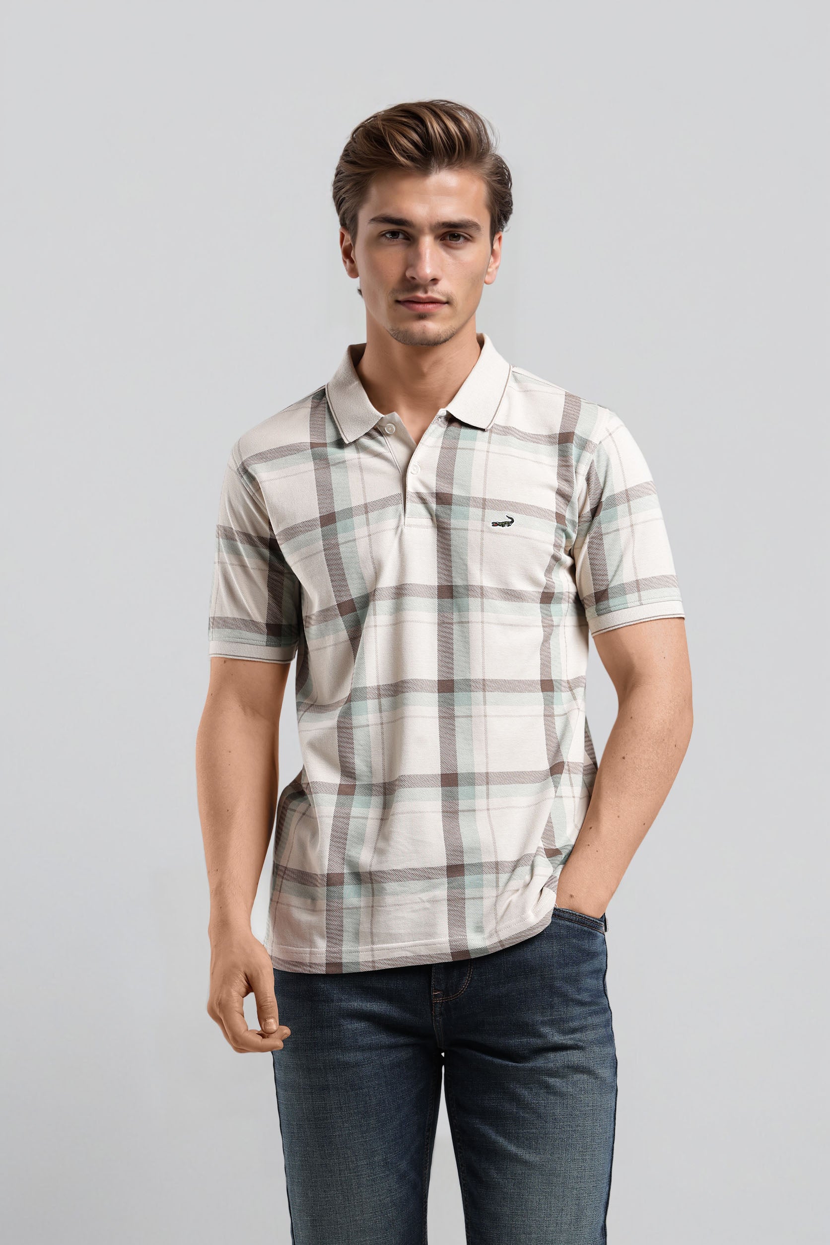 Man wearing a plaid shirt and jeans on a gray background