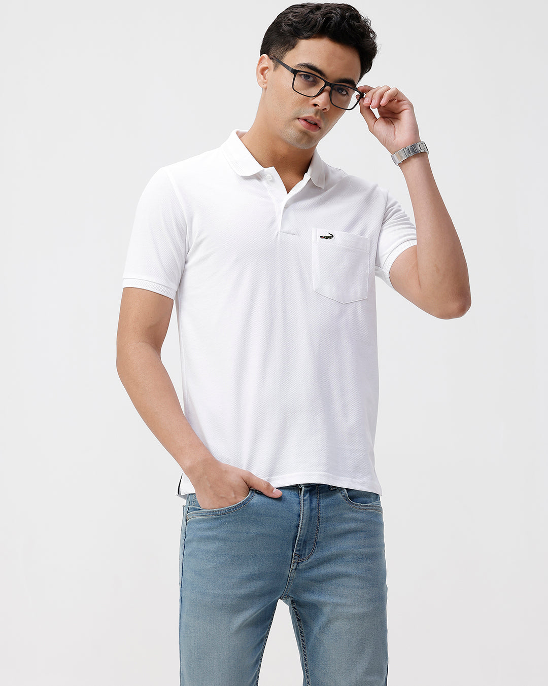 Man wearing a white solid white slim fit polo t shirt with casual styling on a gray background