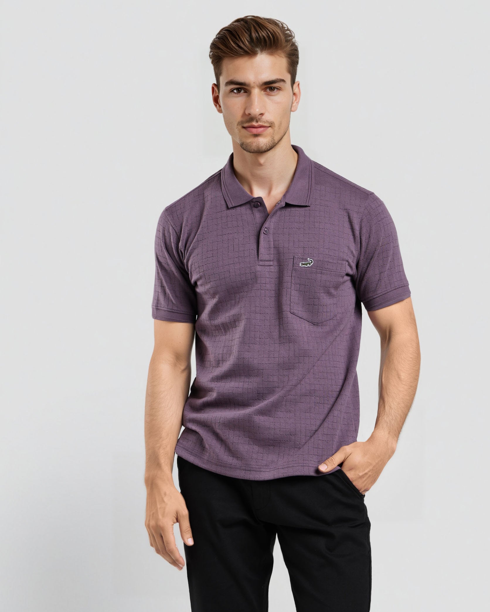 Man wearing a purple polo shirt with a logo on a light gray background