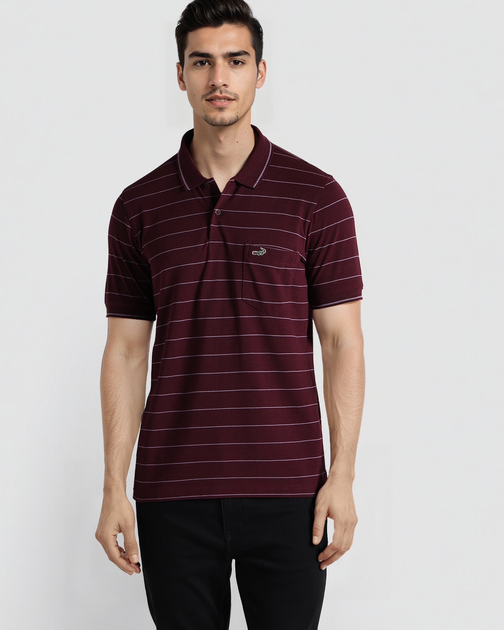 Man wearing a maroon striped polo shirt on a white background