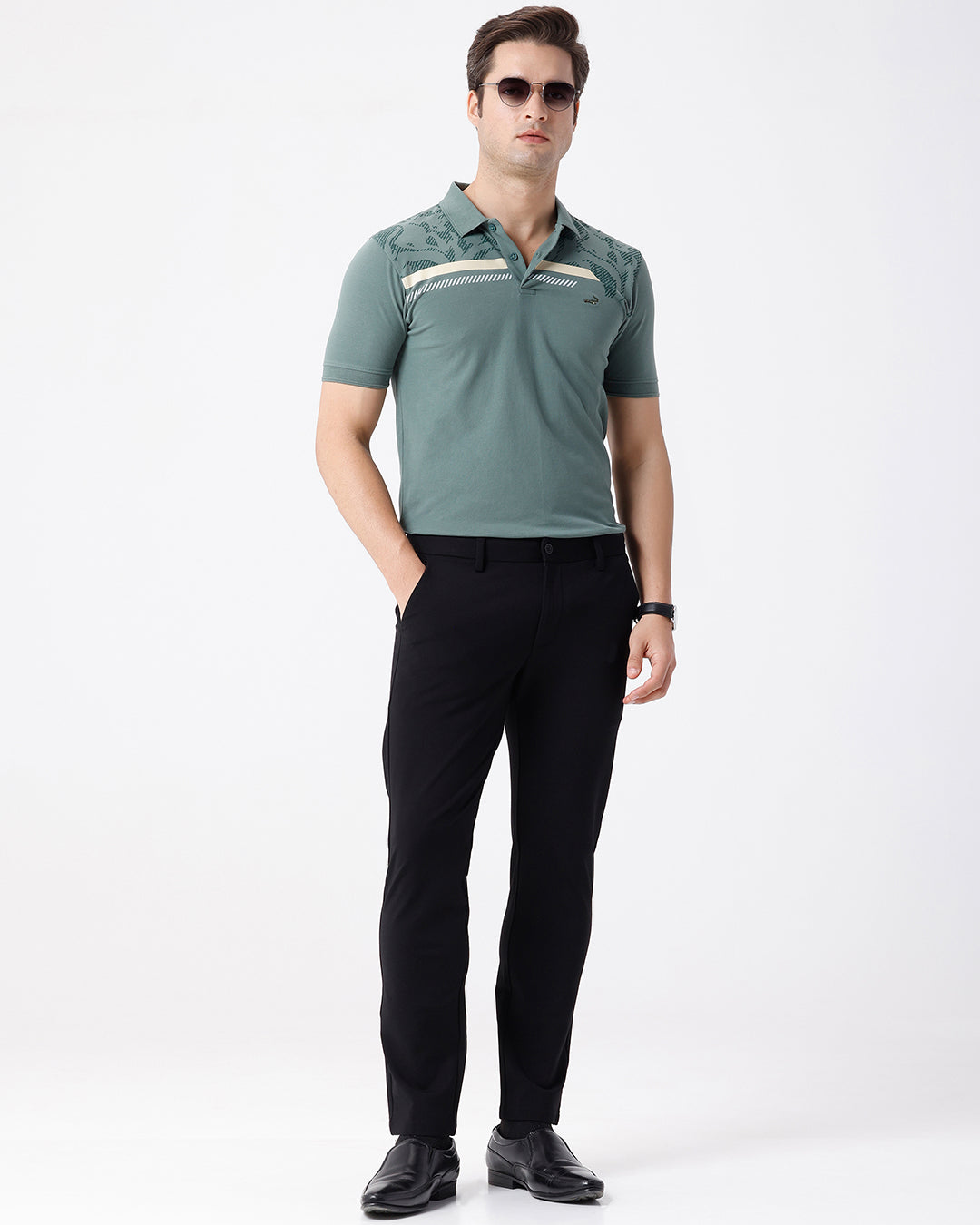 Man wearing a green iceberg green chest print slim fit polo t shirt on a light gray background