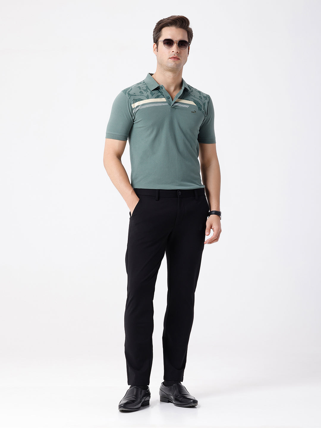 Man wearing a green iceberg green chest print slim fit polo t shirt on a light gray background