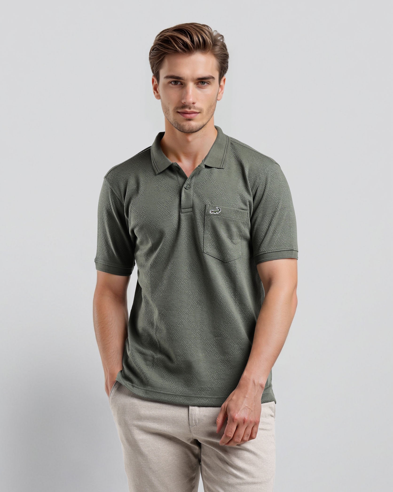 Man wearing a green polo shirt with a pocket on a light gray background