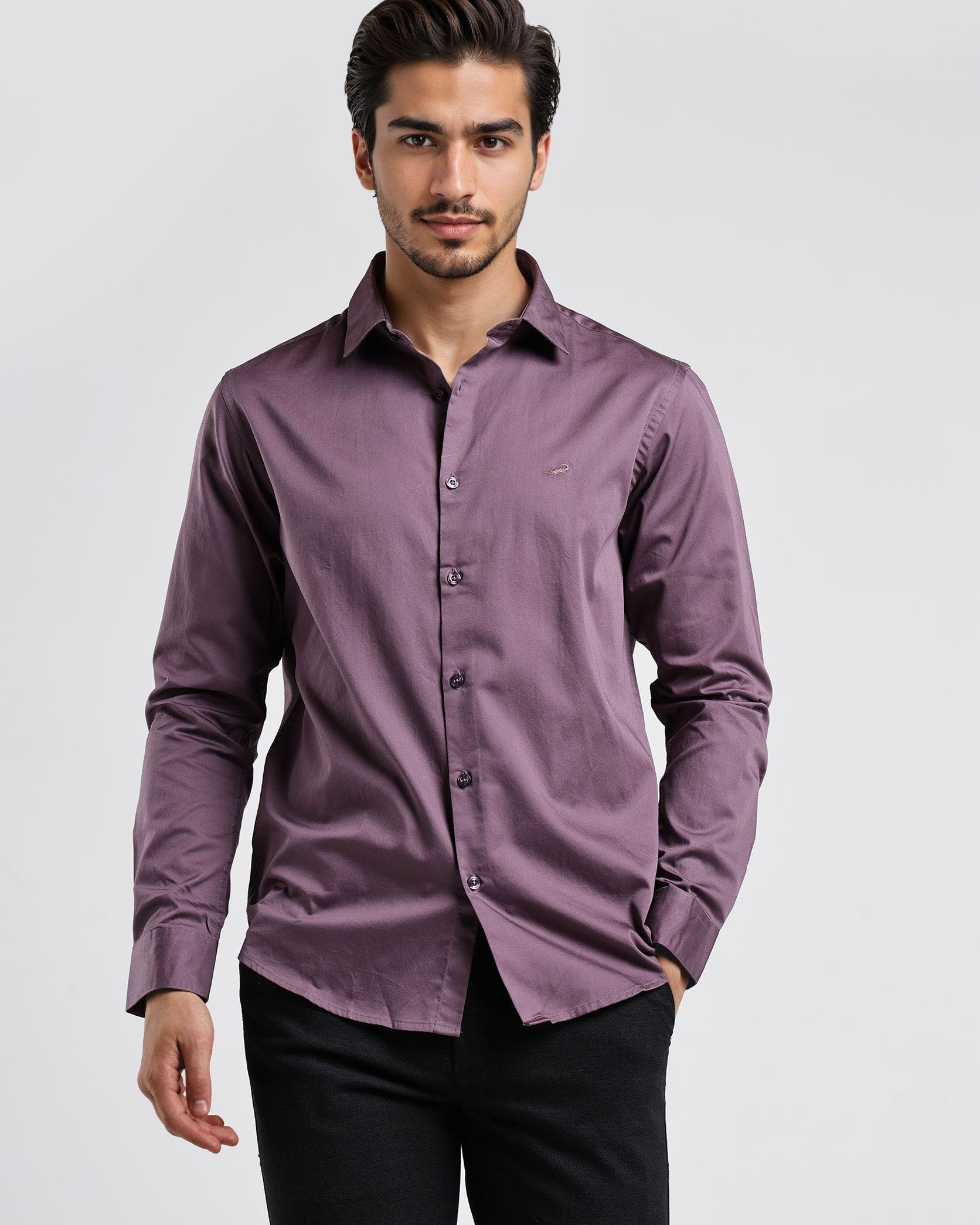 Man wearing a purple shirt and black pants on a white background