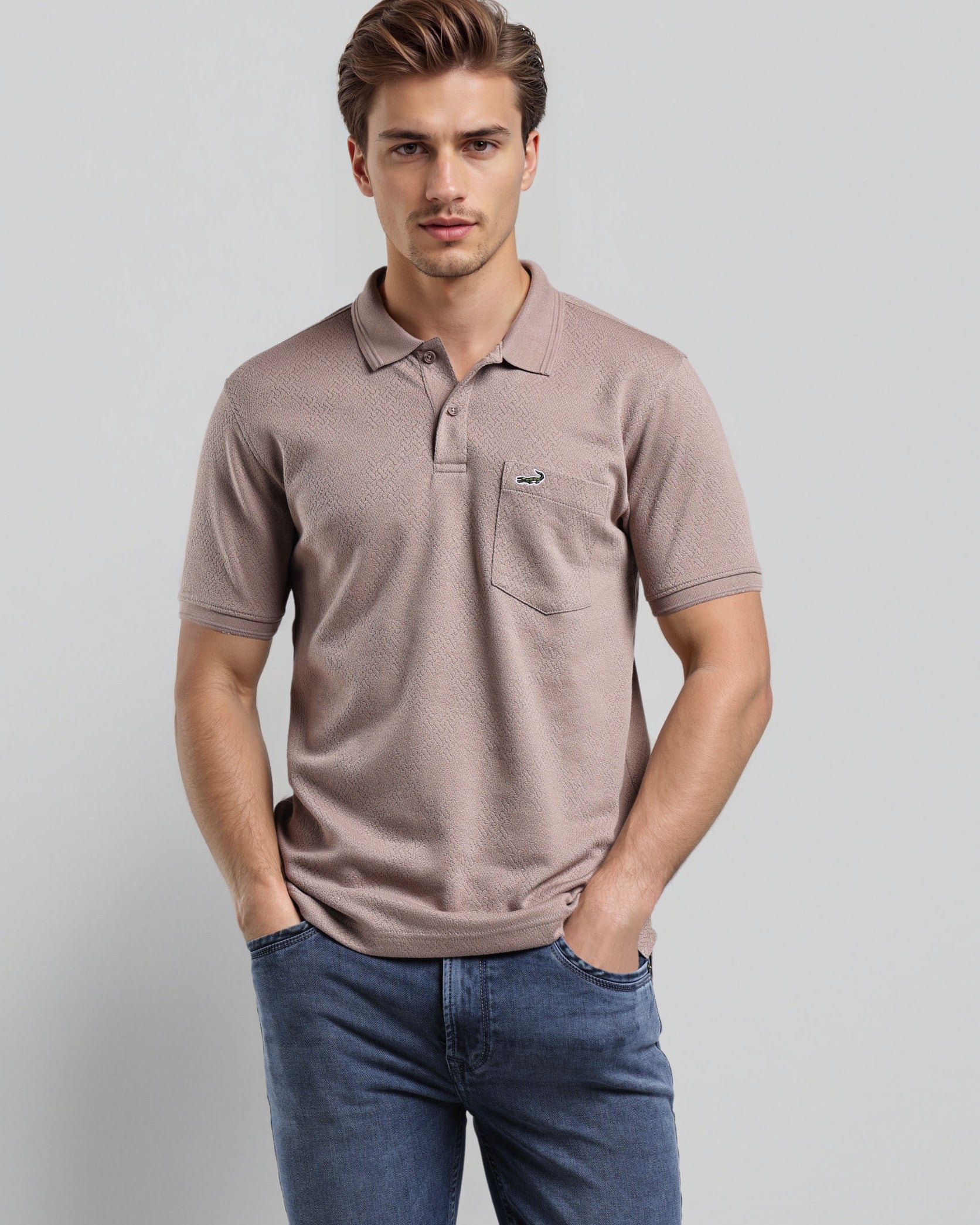 Man wearing a brown polo shirt and blue jeans against a light gray background