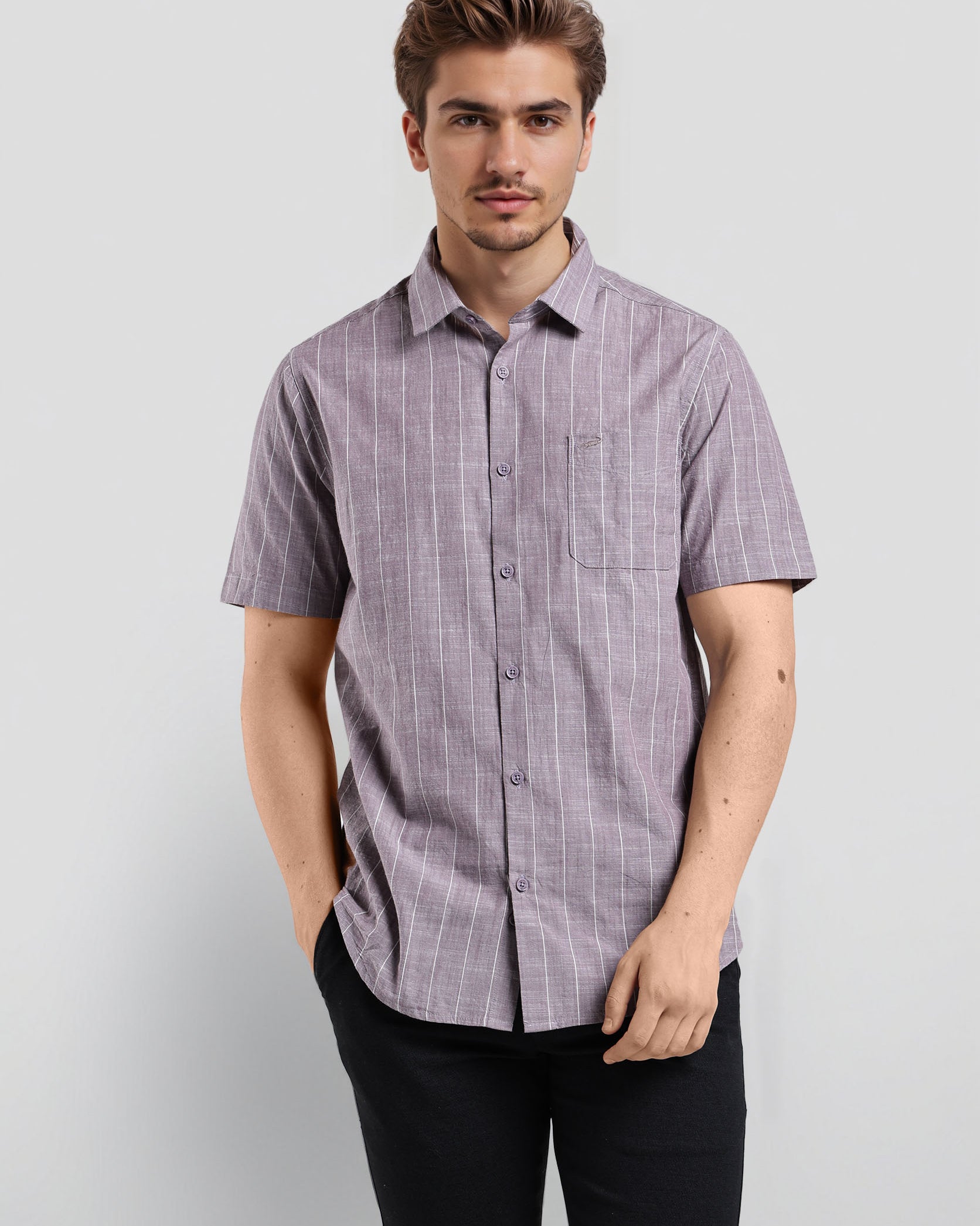 Man wearing a purple checkered shirt against a white background