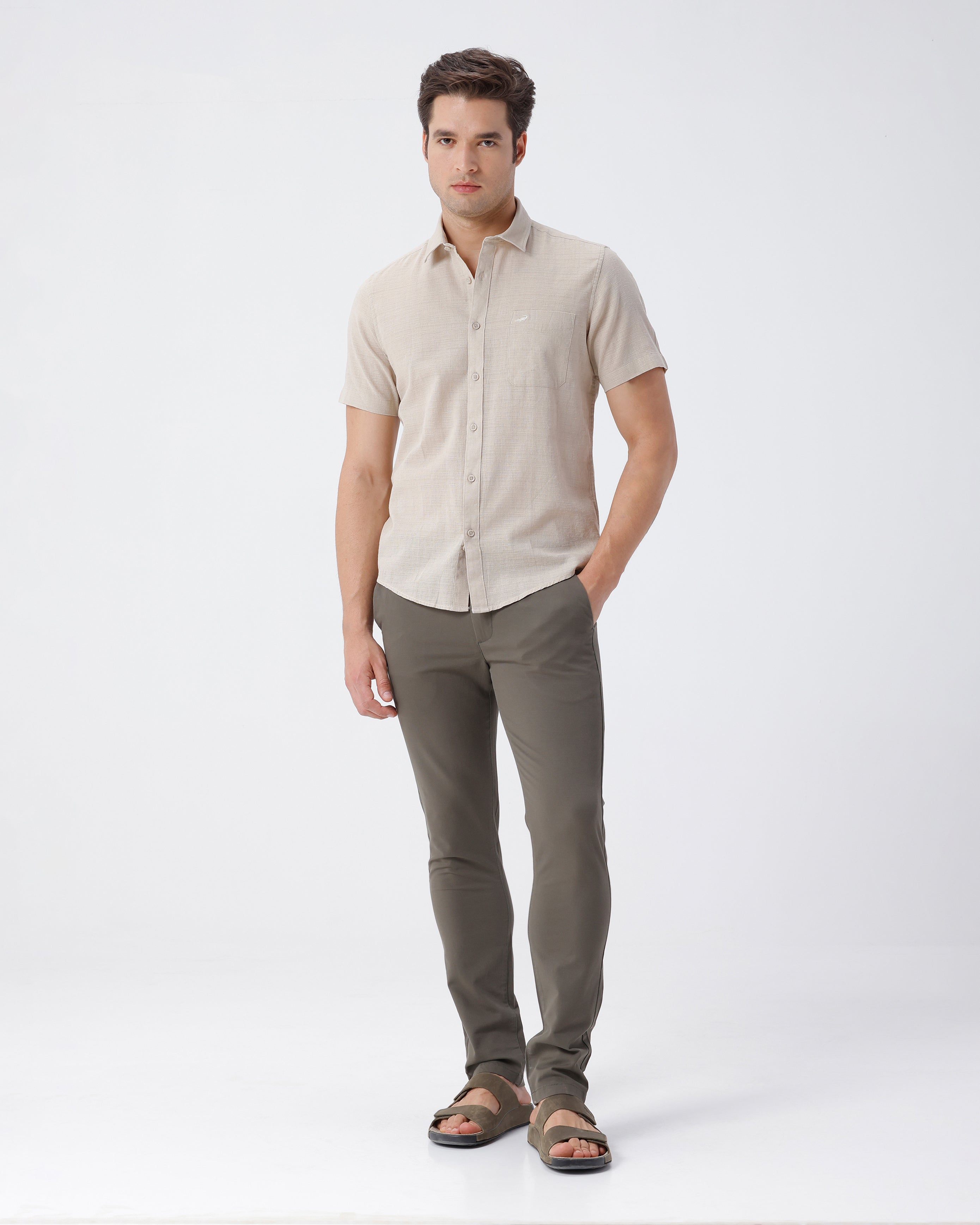 Man wearing a beige pure cotton textured shirt beige on a light gray background