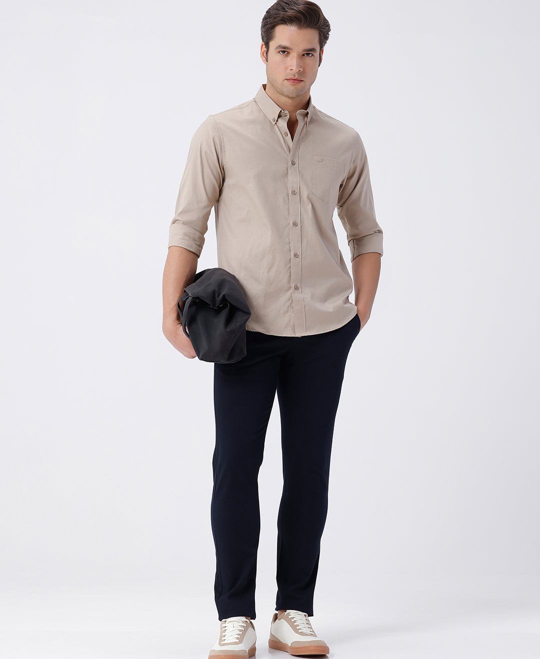 Man wearing a brown smart series premium oxford shirt brown with casual styling on a gray background