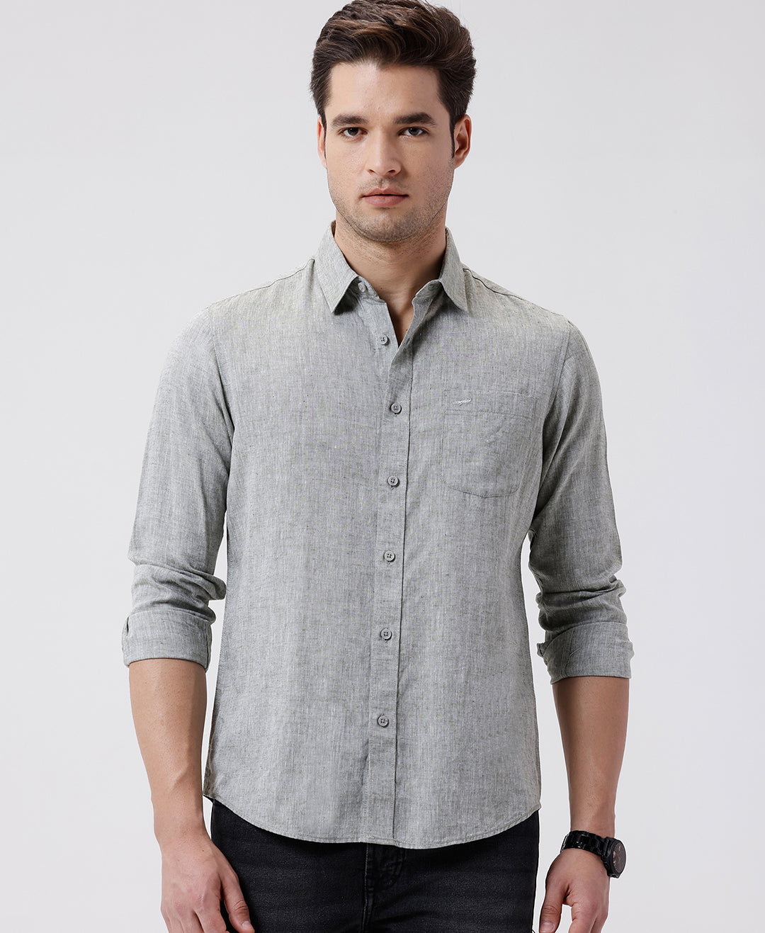 Man wearing a green premium tensil linen shirt dark green on a light gray background