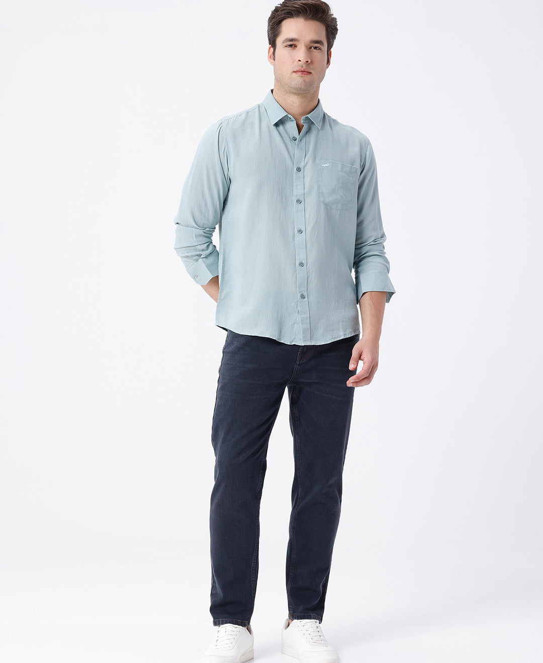 Man wearing a green linen blend shirt in green on a light gray background