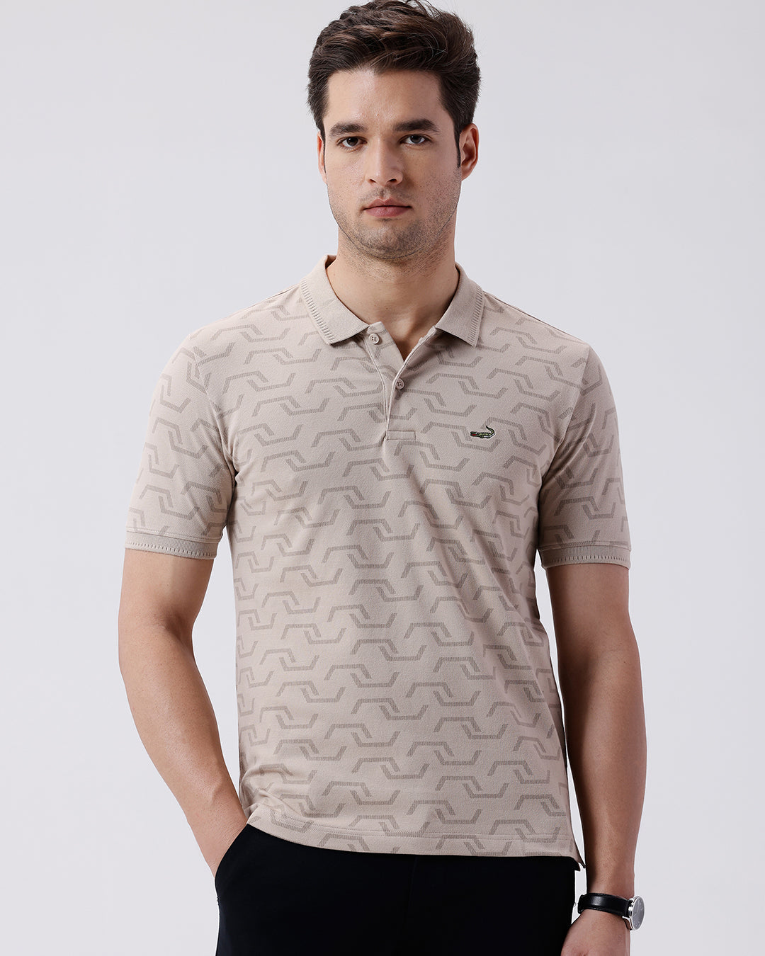 Man wearing a all over printed subtle texture polo t shirt on a light gray background