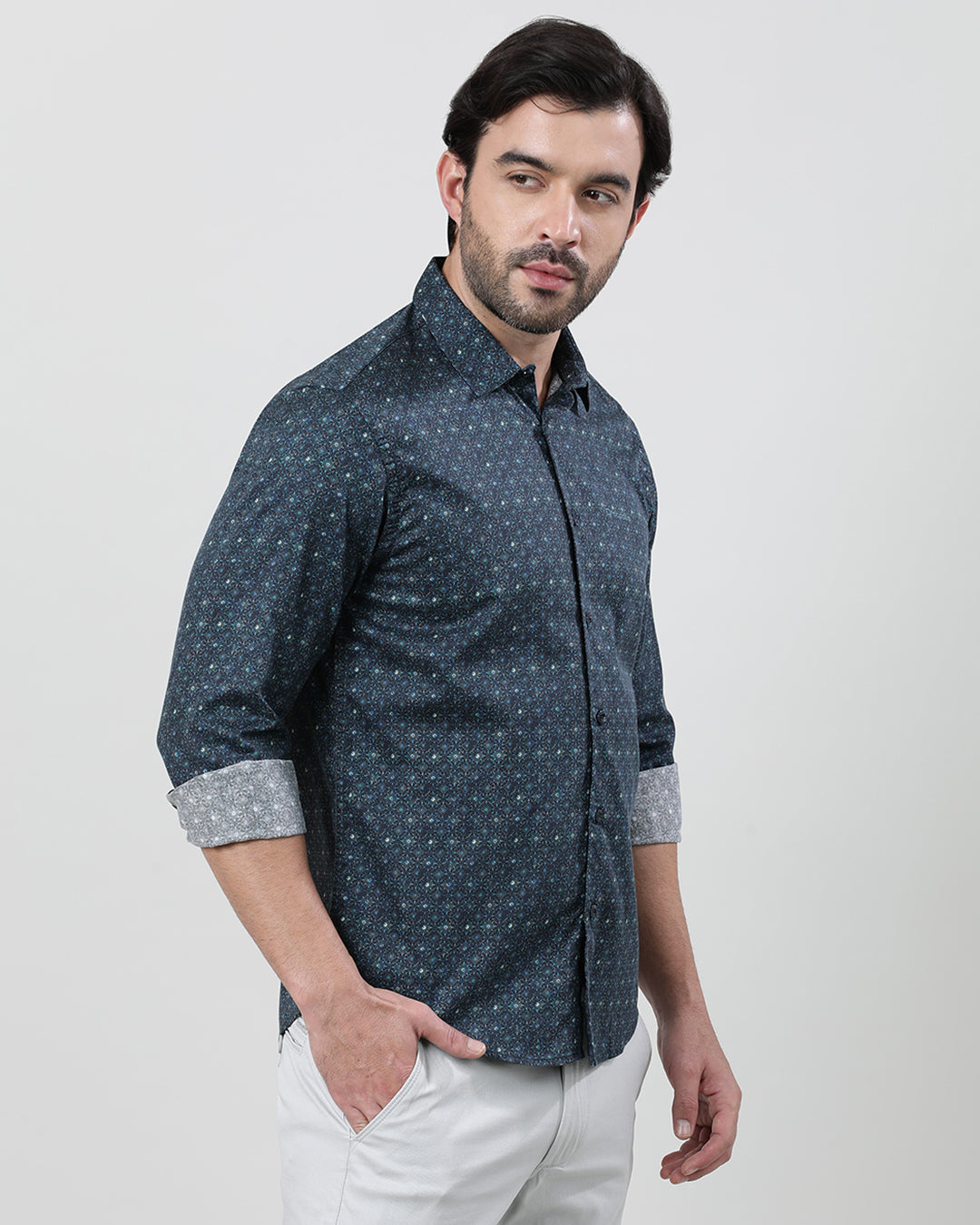 Man wearing a blue dark blue printed full sleeve 100% cotton shirt with casual styling on a gray background